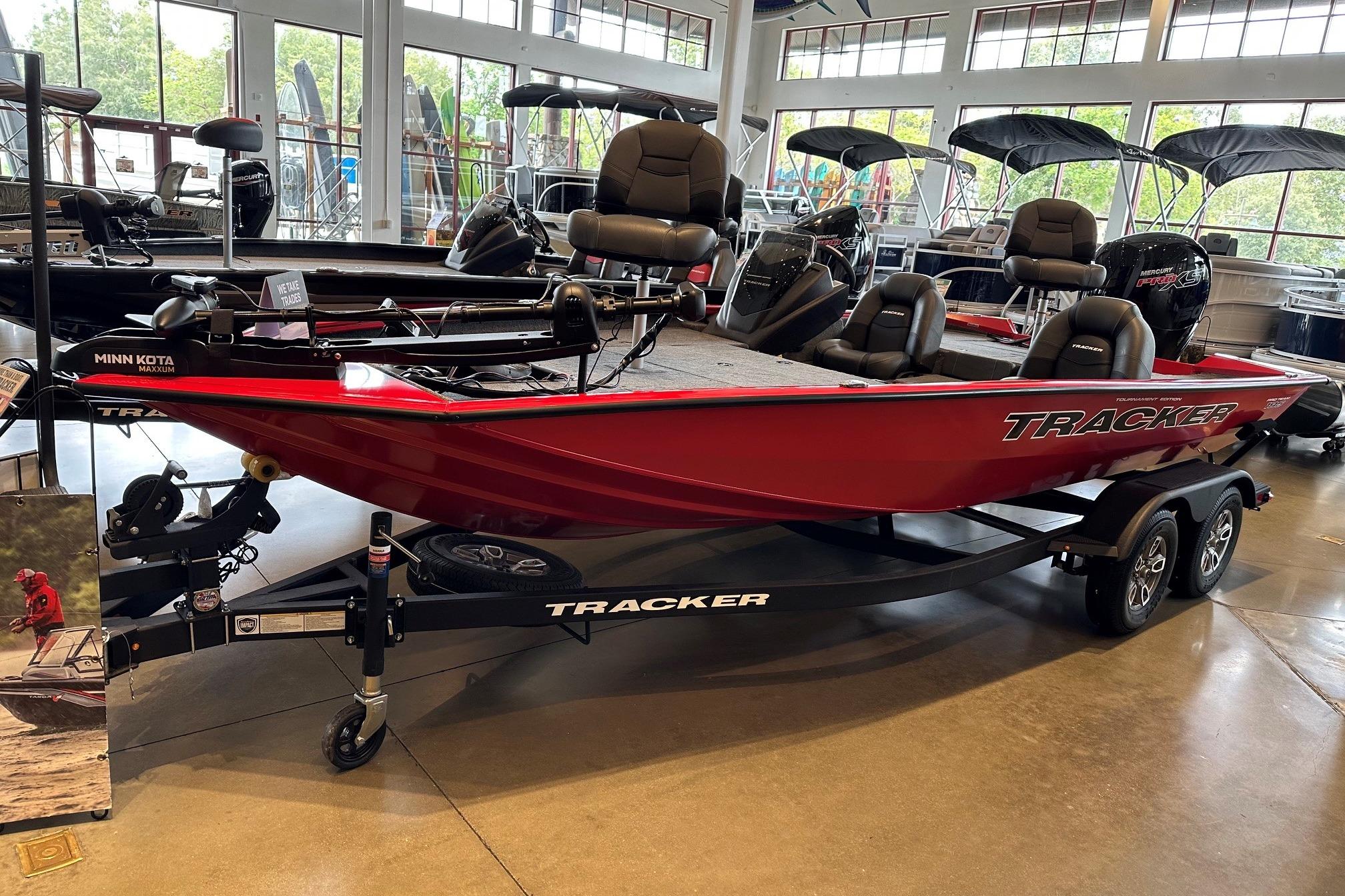 2026 Tracker Pro Team 195 boat in showroom, red exterior, on trailer.