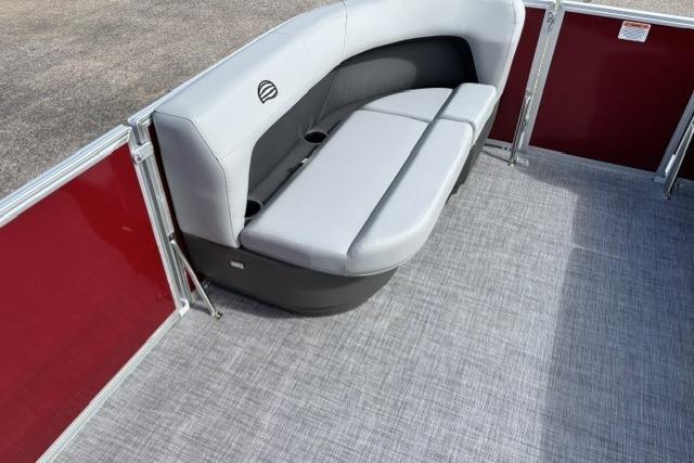2026 Sun Tracker Party Barge 16 DLX interior with gray seating and red paneling.