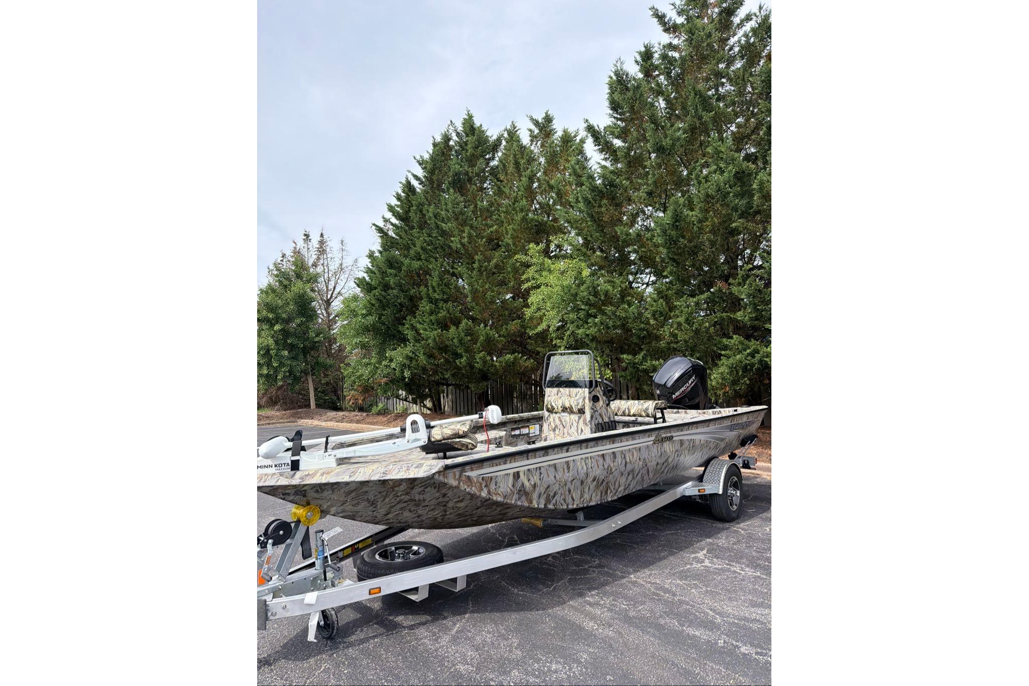 2026 Ranger RB190 boat on trailer, camo design, parked near trees.