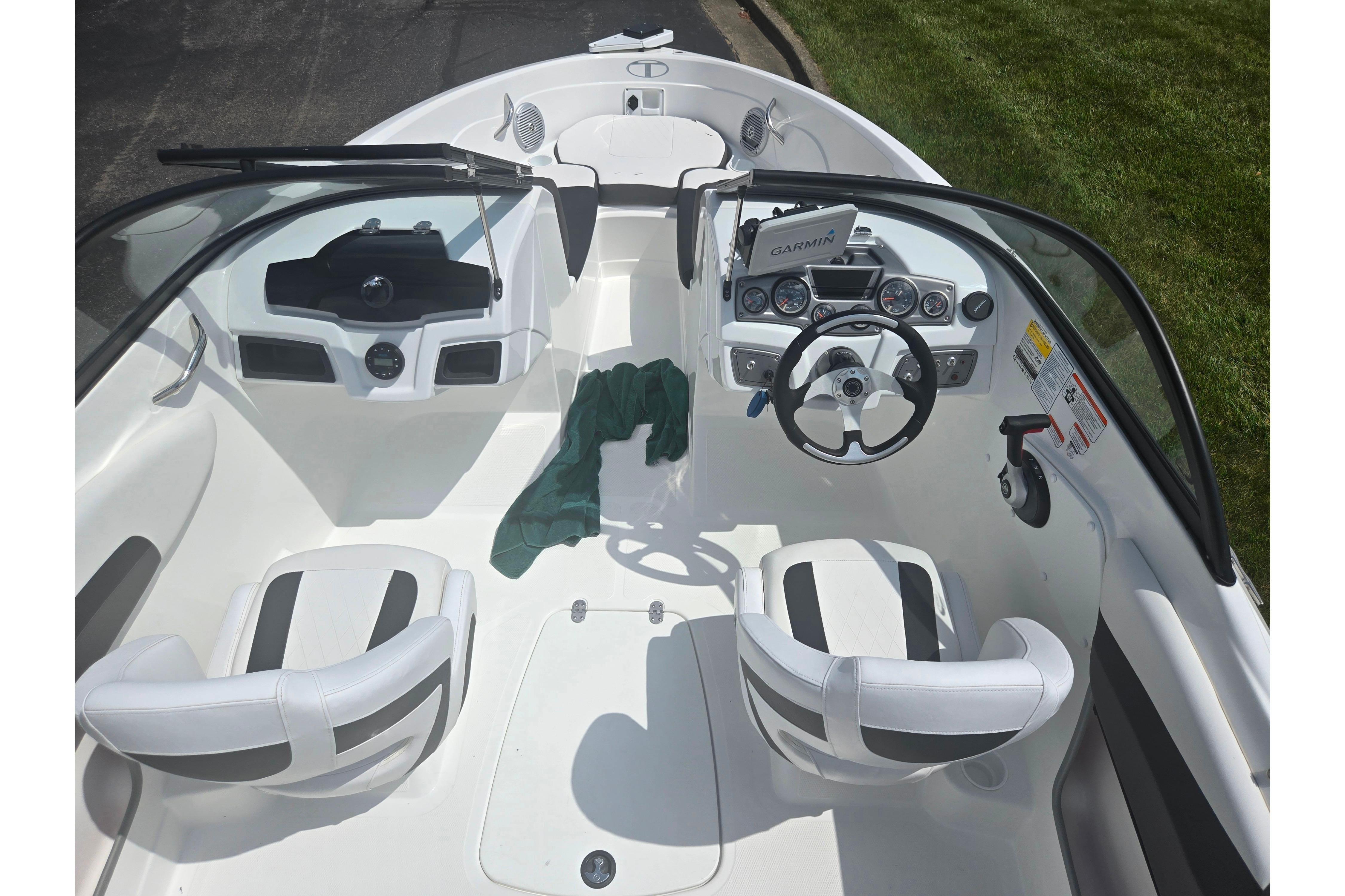 2023 Tahoe 200 S boat interior with steering wheel, seats, and Garmin navigation system.