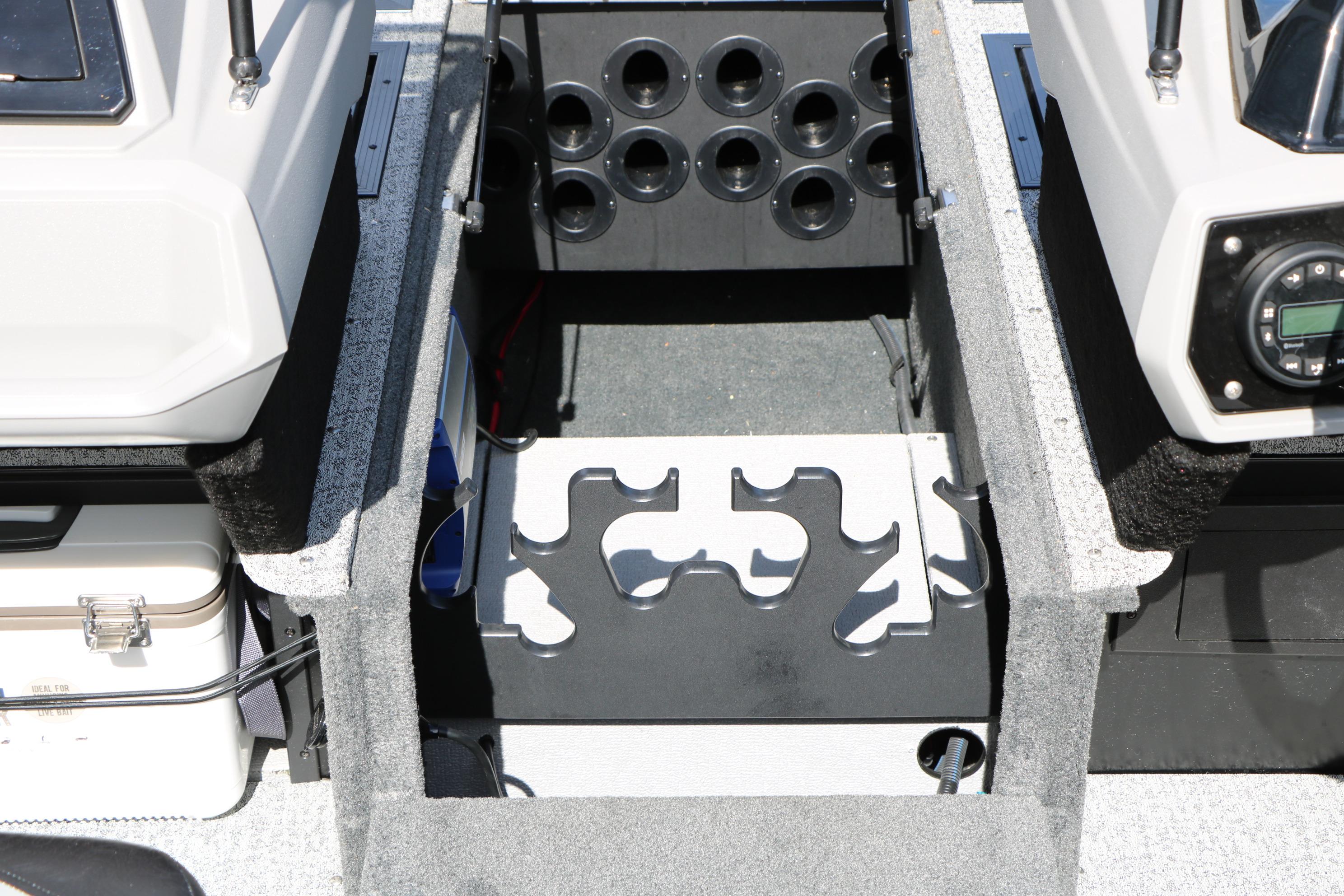 Interior of 2025 Smoker Craft Adventurer 188 DC boat, featuring storage compartments and control panel.