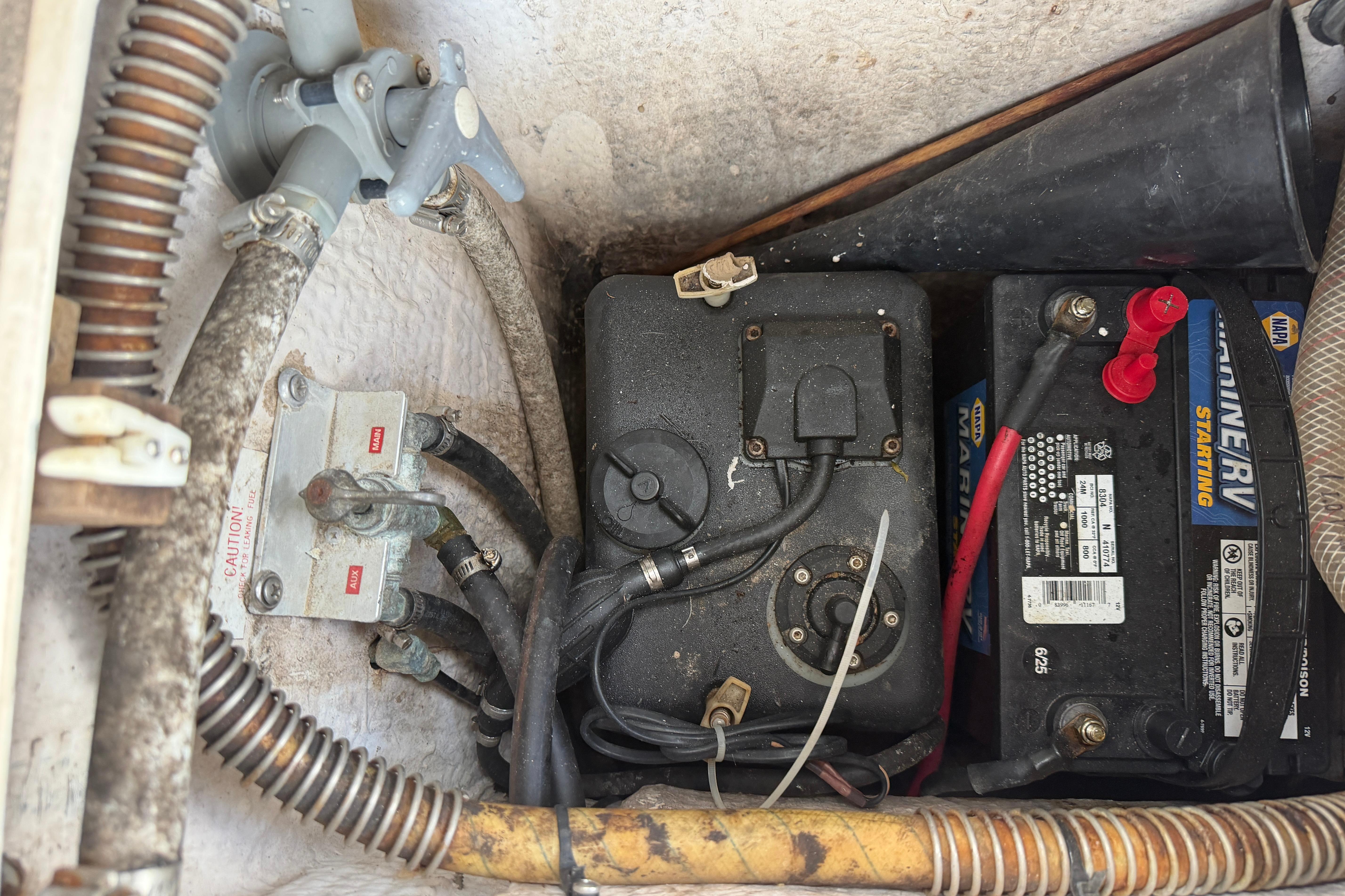 1987 Grady-White Seafarer 226 boat battery compartment with wiring and marine equipment.