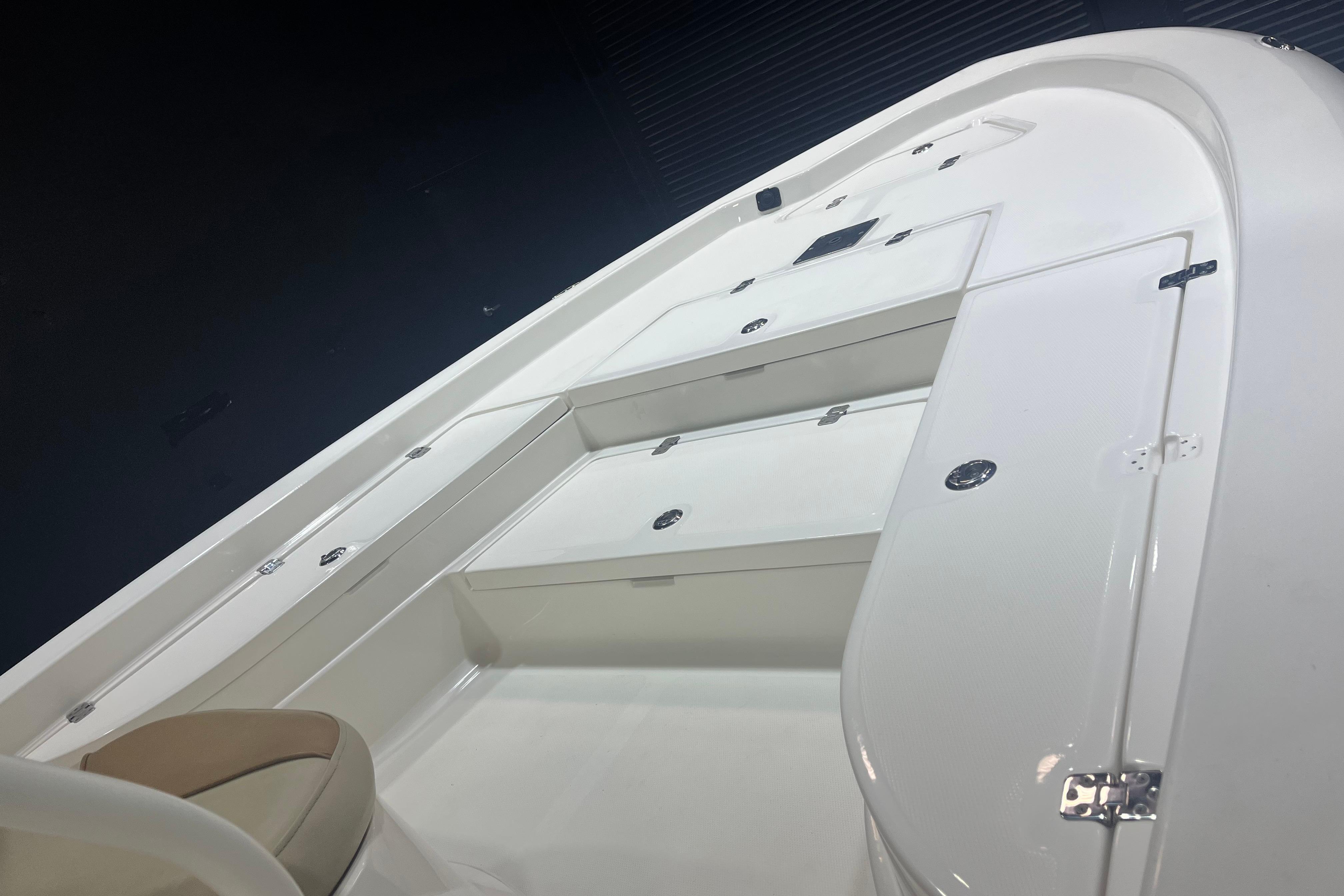 2023 NauticStar 227 XTS boat interior with sleek white design and storage compartments.