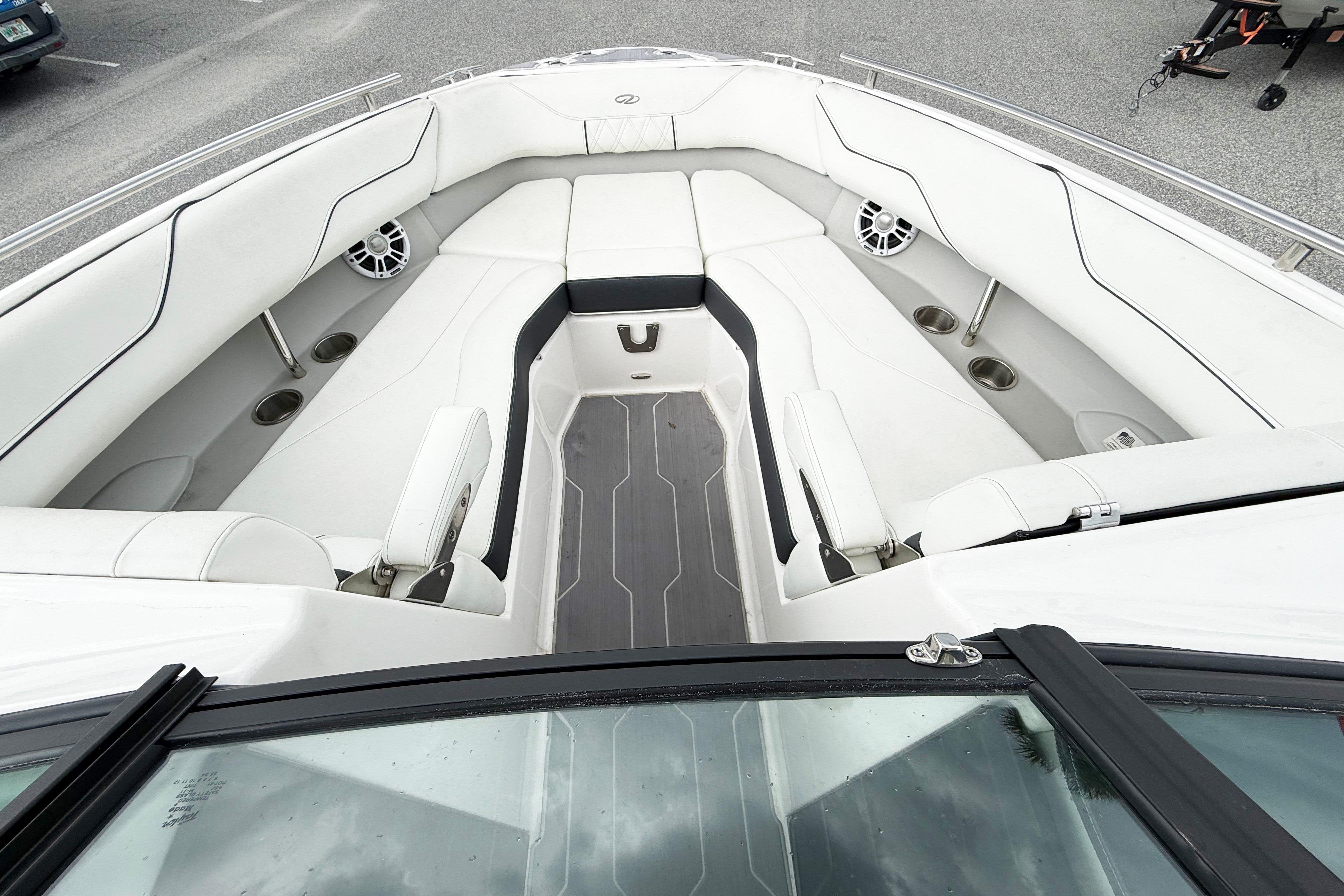 2024 Regal LX4 boat interior with white seating and cup holders.
