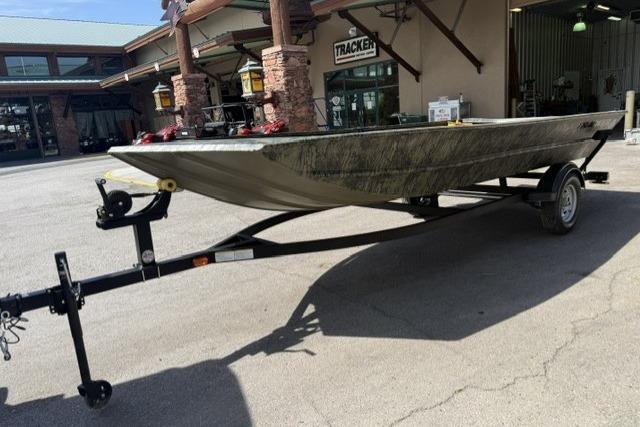2026 Tracker Grizzly 1754 Utility boat on trailer outside dealership.