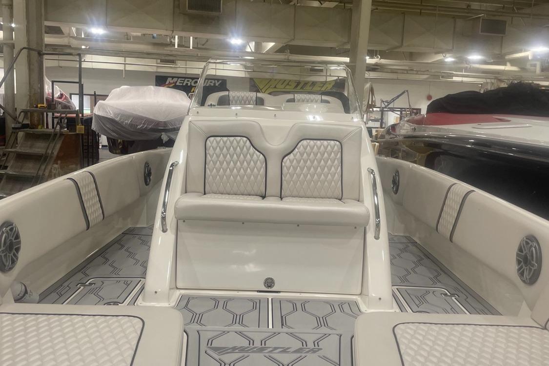 2025 Hustler 25 C3 Speedfish boat interior with cushioned seating and modern design.