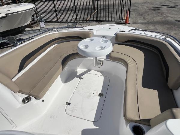 2022 Hurricane Center Console SS 231 OB boat with beige seating and round table.