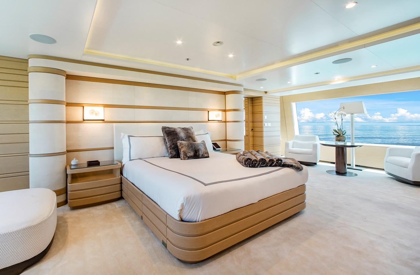 Luxurious bedroom on 2016 Benetti FB264 yacht with ocean view and modern decor.