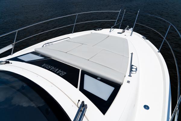 2022 Bavaria SR41 yacht deck with sunbathing area, sleek design, and railing.