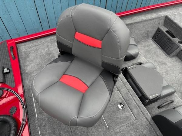 2025 Tracker Savage 215 boat seat with gray and red upholstery, set against a blue background.