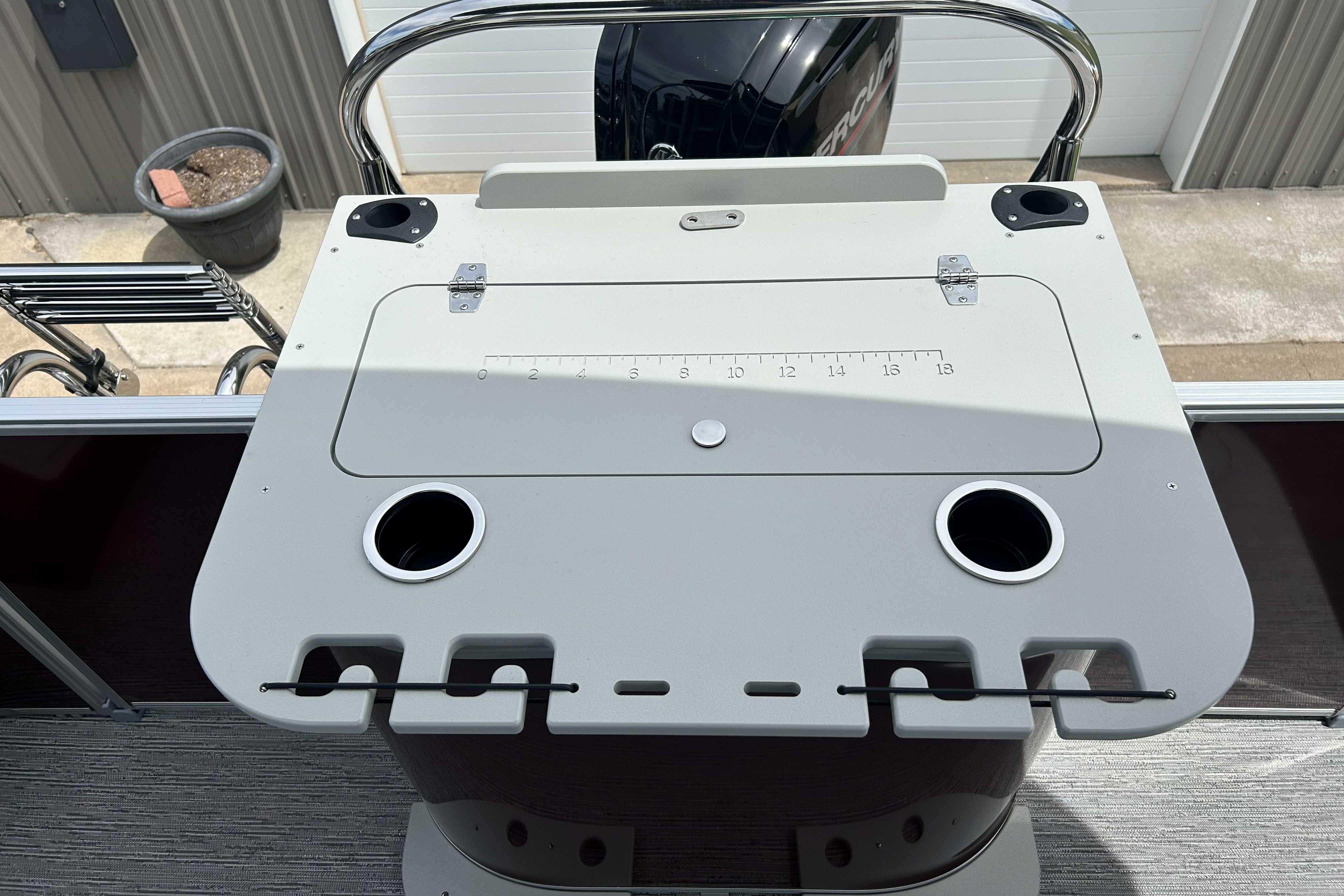Fishing station on 2026 Starcraft EX 20 F boat with rod holders and cup holders.