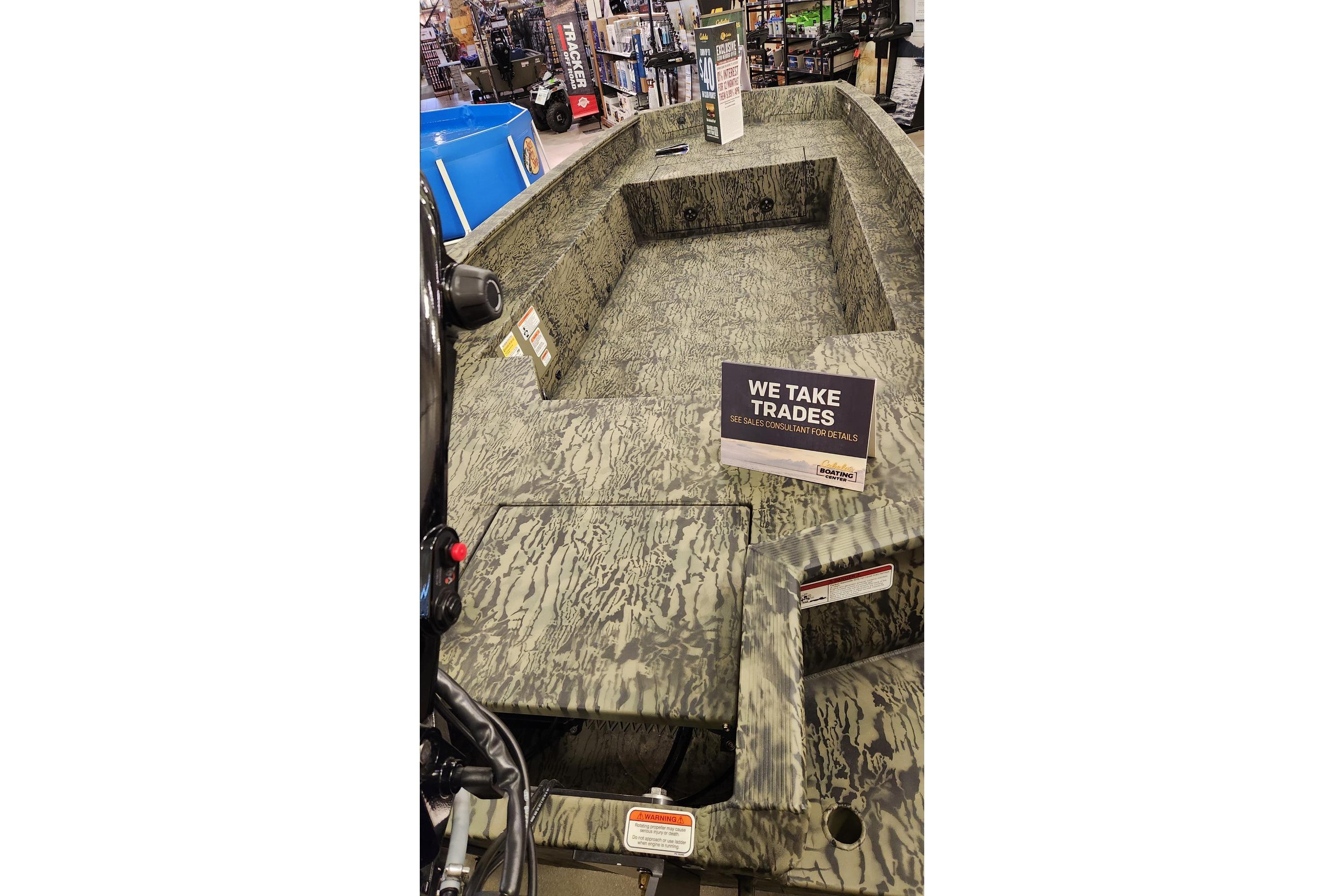 2025 Tracker Grizzly 1650 T Prairie Wings Edition boat on display with trade-in sign.