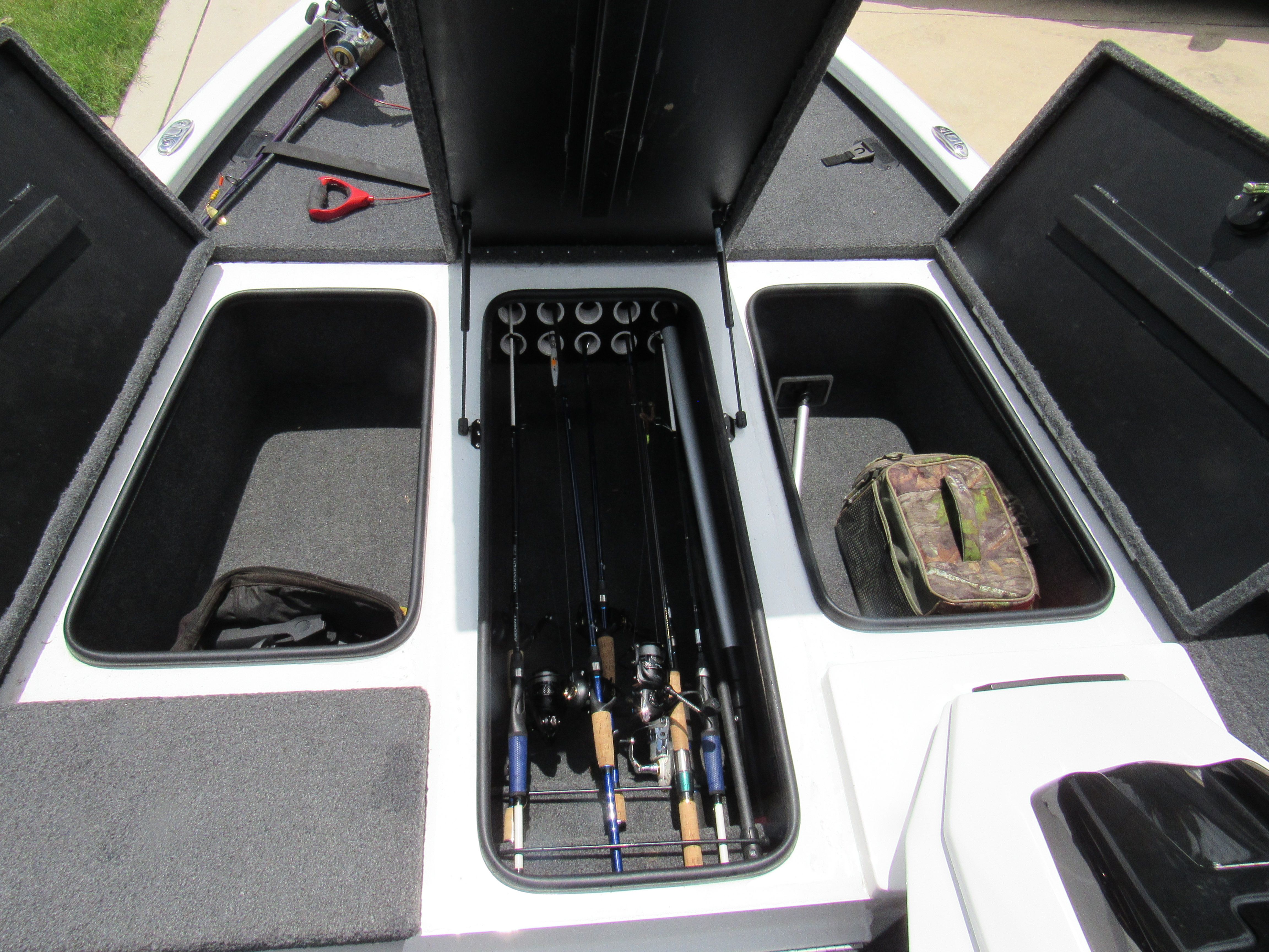 The image shows the interior of a Vexus AVX 1880 boat with fishing rods and storage.