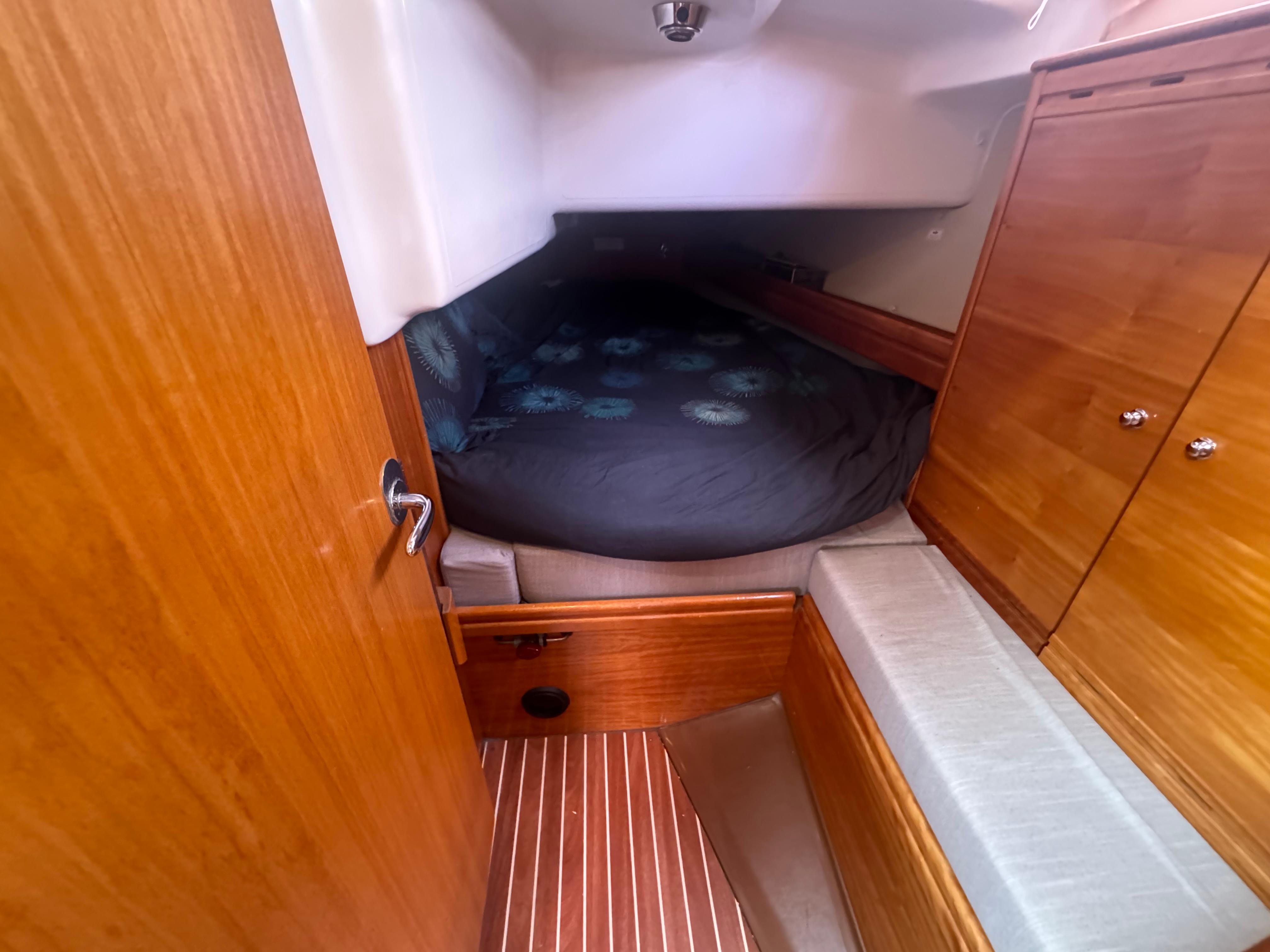 2007 Bavaria 37 Cruiser cabin with wooden interior and cozy sleeping area.