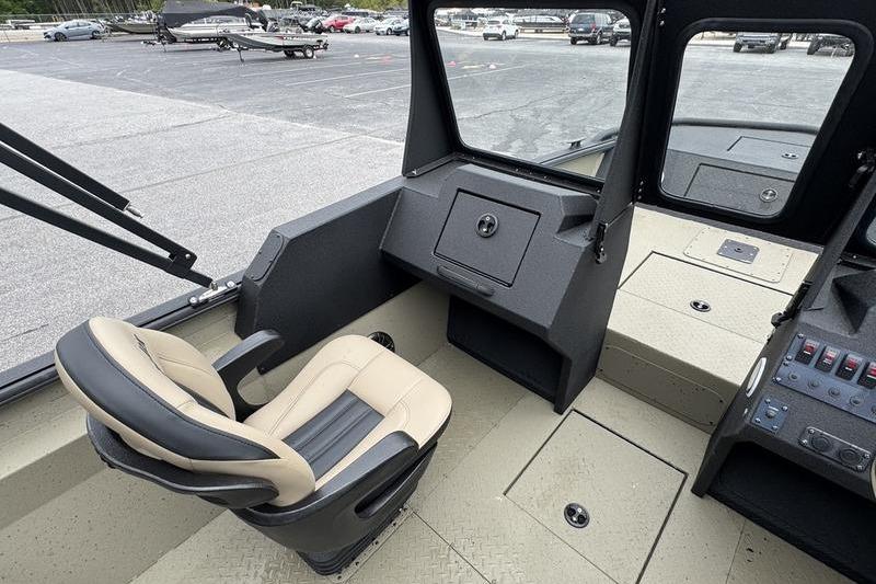 Interior of 2026 SeaArk Predator 300 AK boat, featuring a comfortable captain's chair and control panel.
