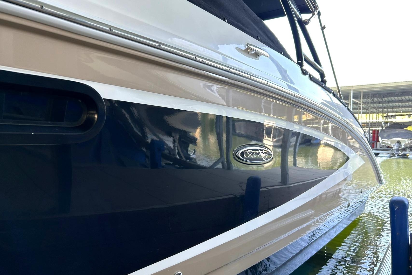 2015 Sea Ray 270 Sundeck boat docked, showcasing sleek design and glossy finish.