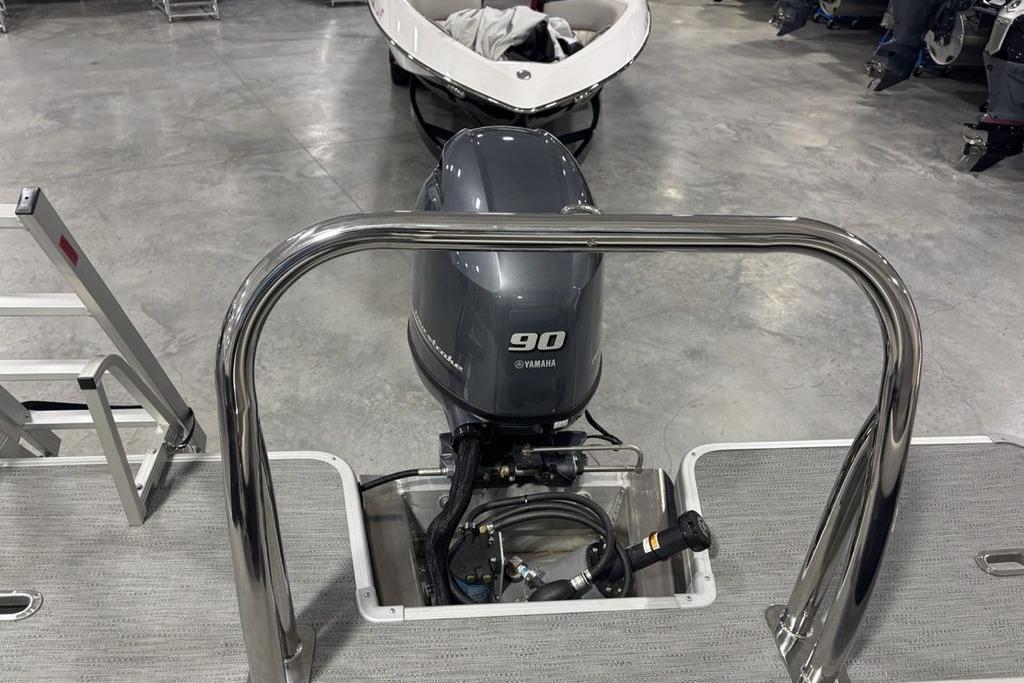 2026 Godfrey Xperience 2086 SFLX boat with Yamaha 90 engine in showroom.
