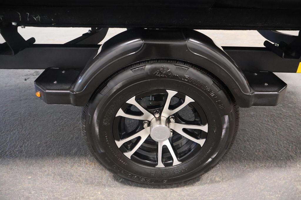 2023 Sea-Doo Switch Sport Compact trailer wheel with black and silver alloy rim.