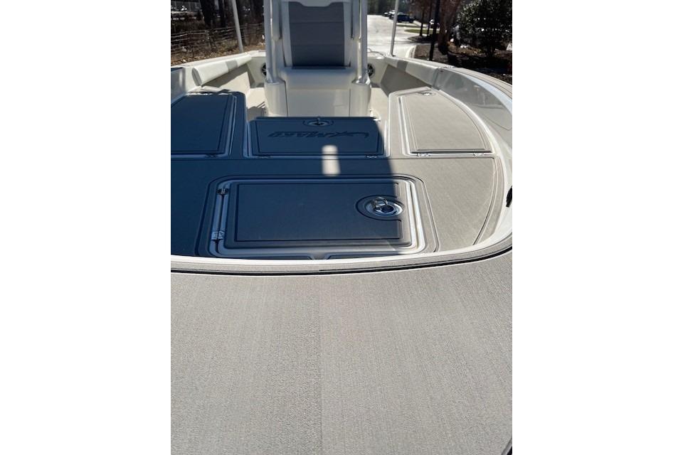 2026 Mako 24 APEX boat deck with sleek design and storage compartments.