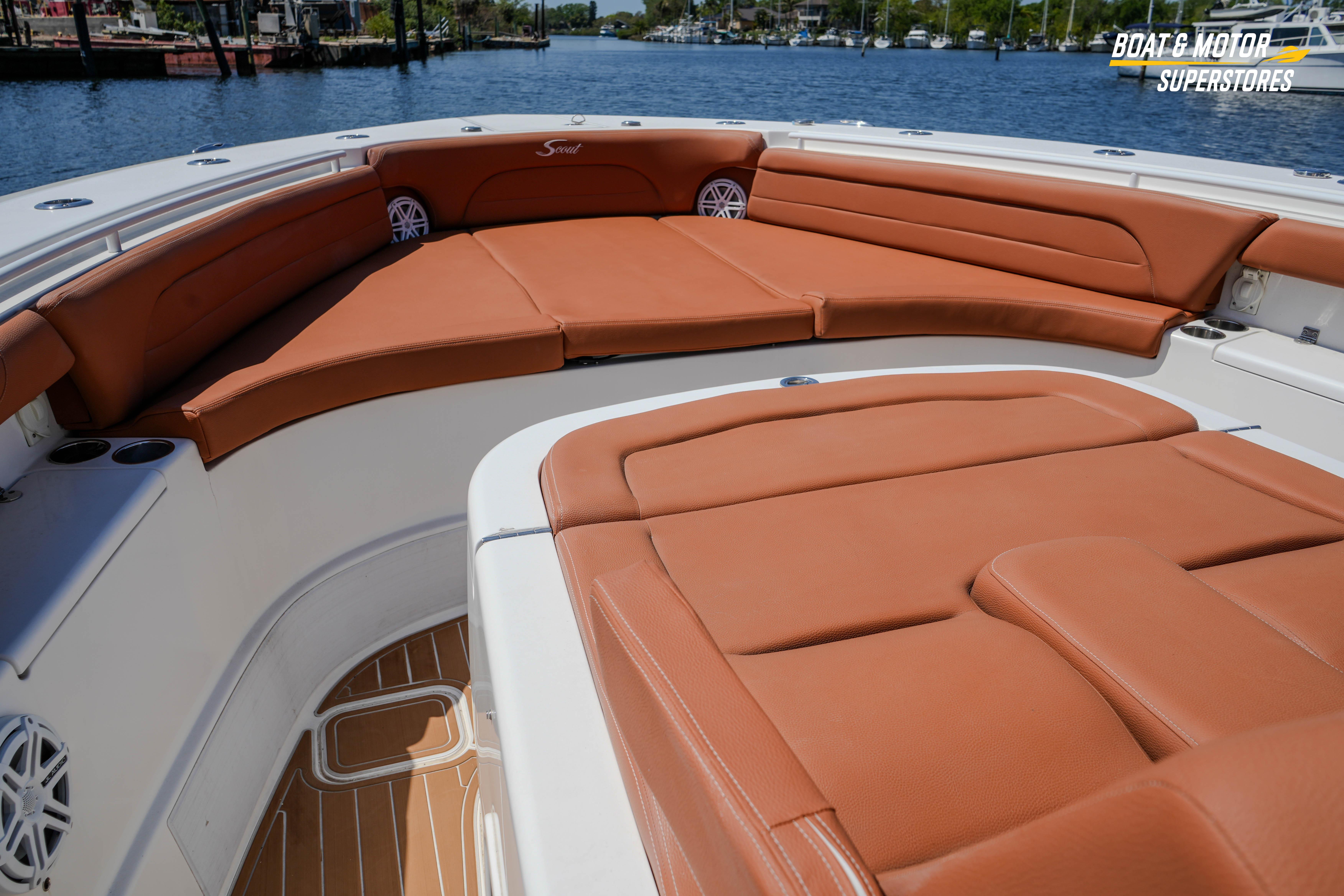 Luxurious seating on 2019 Scout 420 LXF boat, featuring tan leather upholstery and spacious deck.
