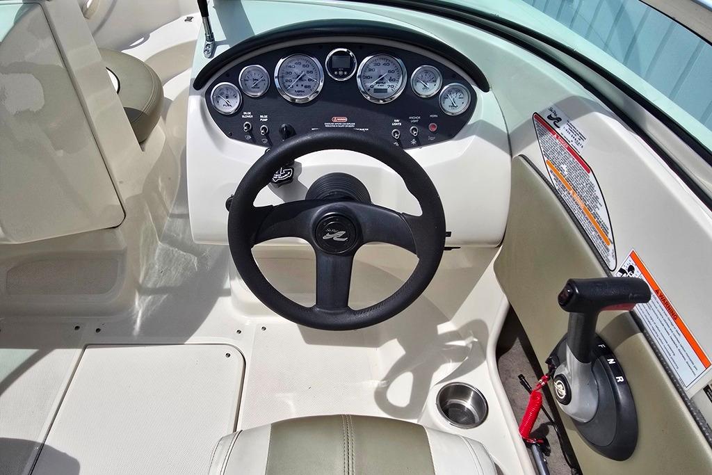Steering console of a 2006 Sea Ray 185 Sport boat with gauges and controls.