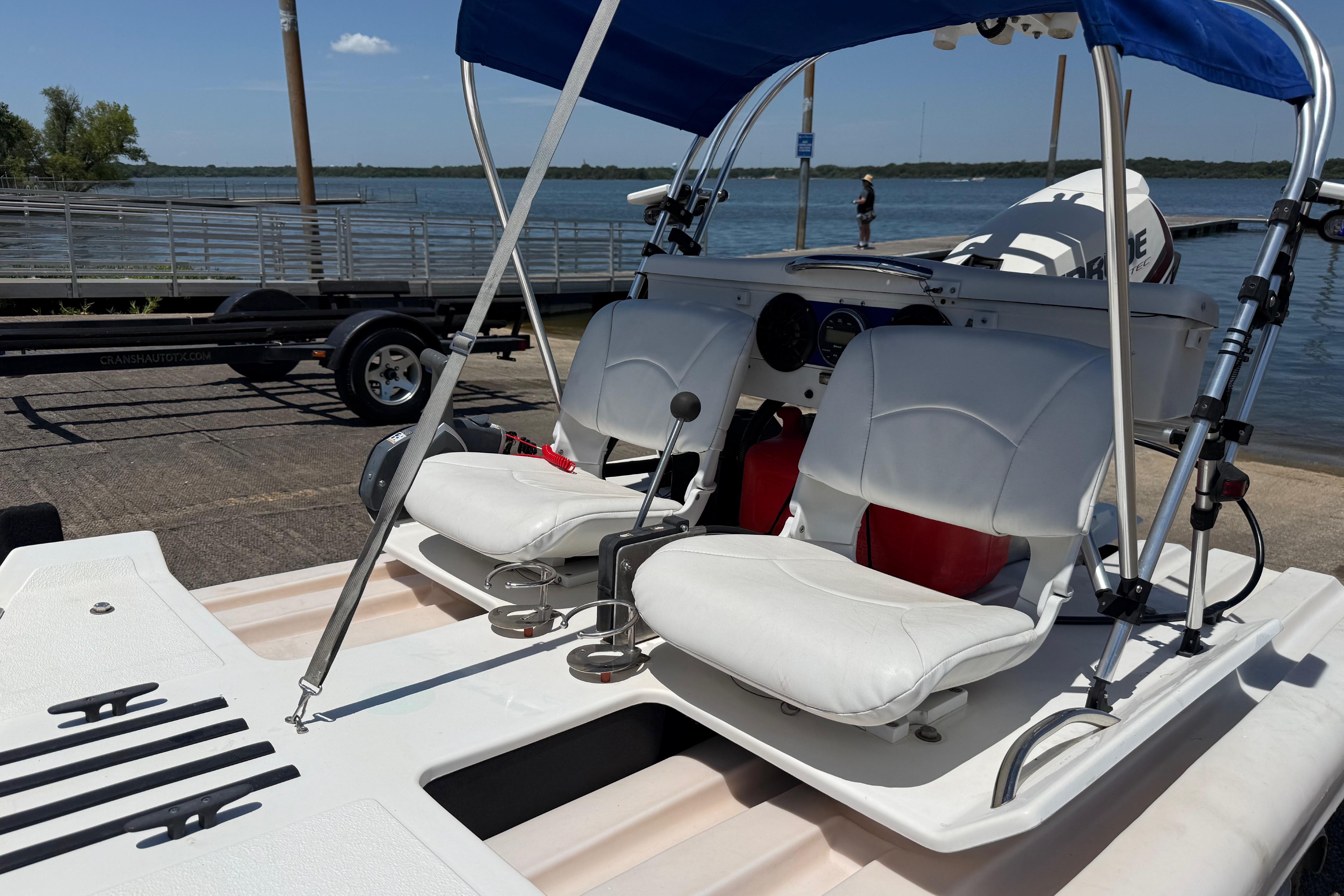 2016 CraigCat E2 Elite with white seats and blue canopy by the water.