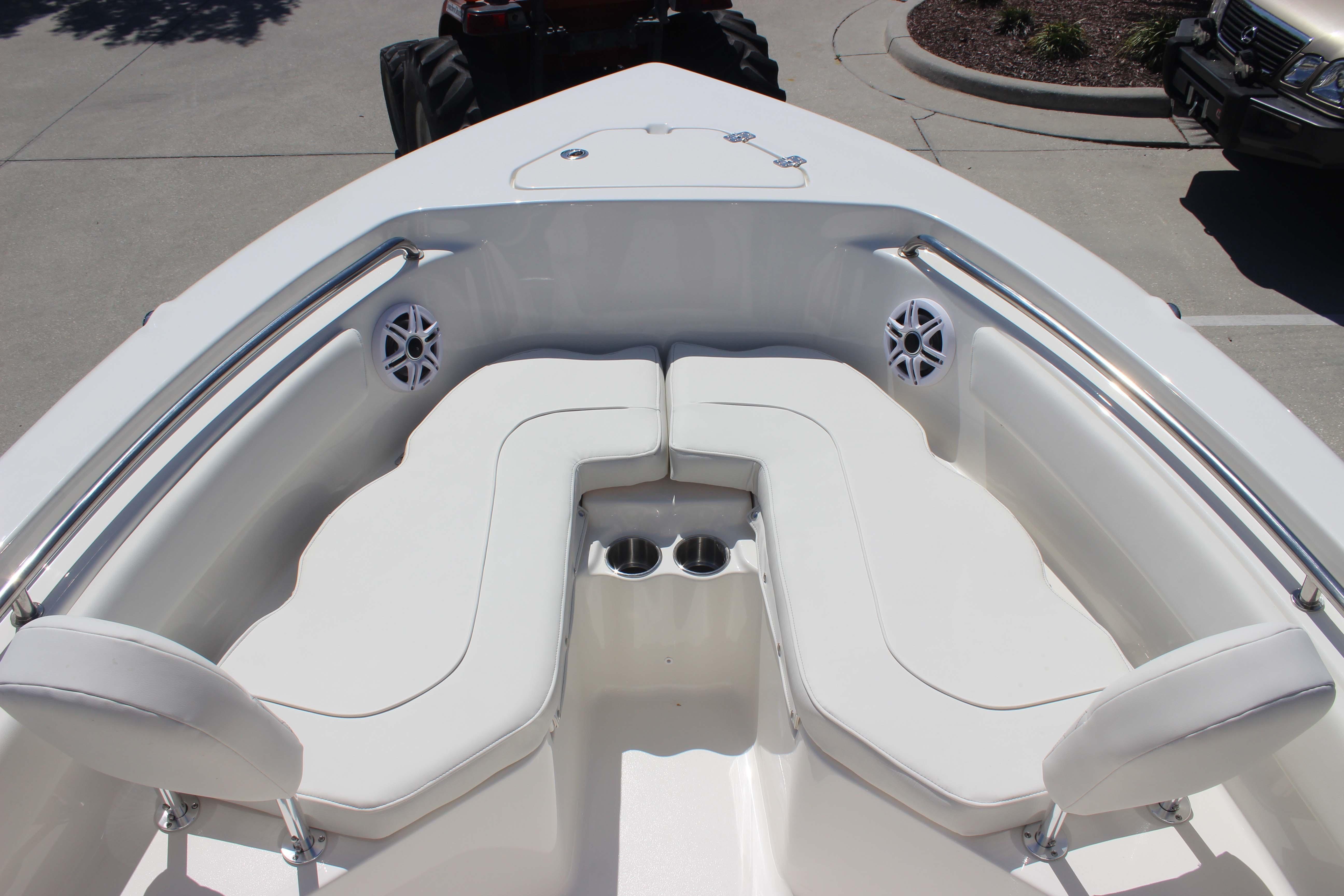 2026 Key West 203 FS boat interior with white cushioned seating and stainless steel railings.