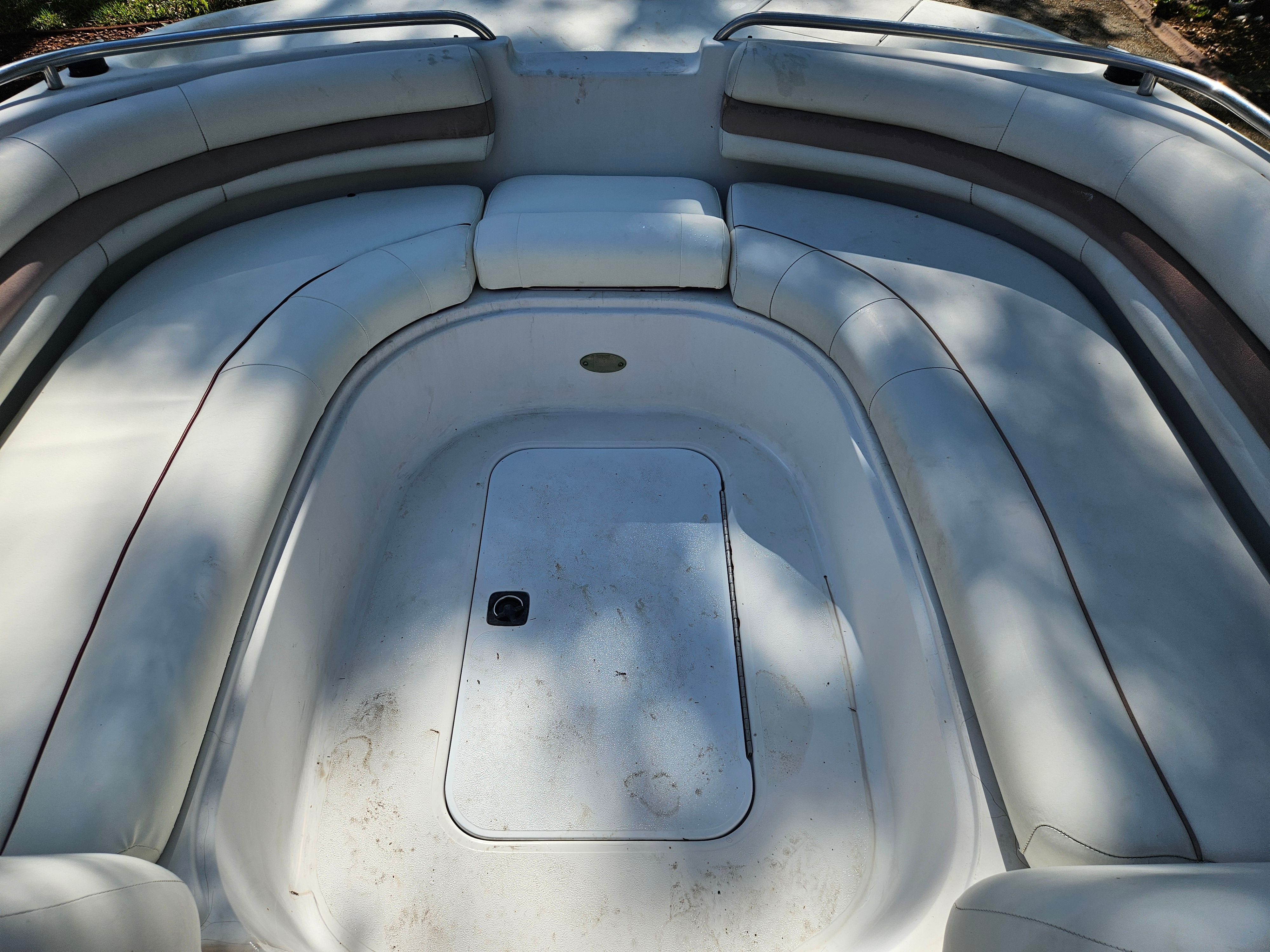 The image shows the bow area of a 2001 Hurricane 237 boat with cushioned seating.