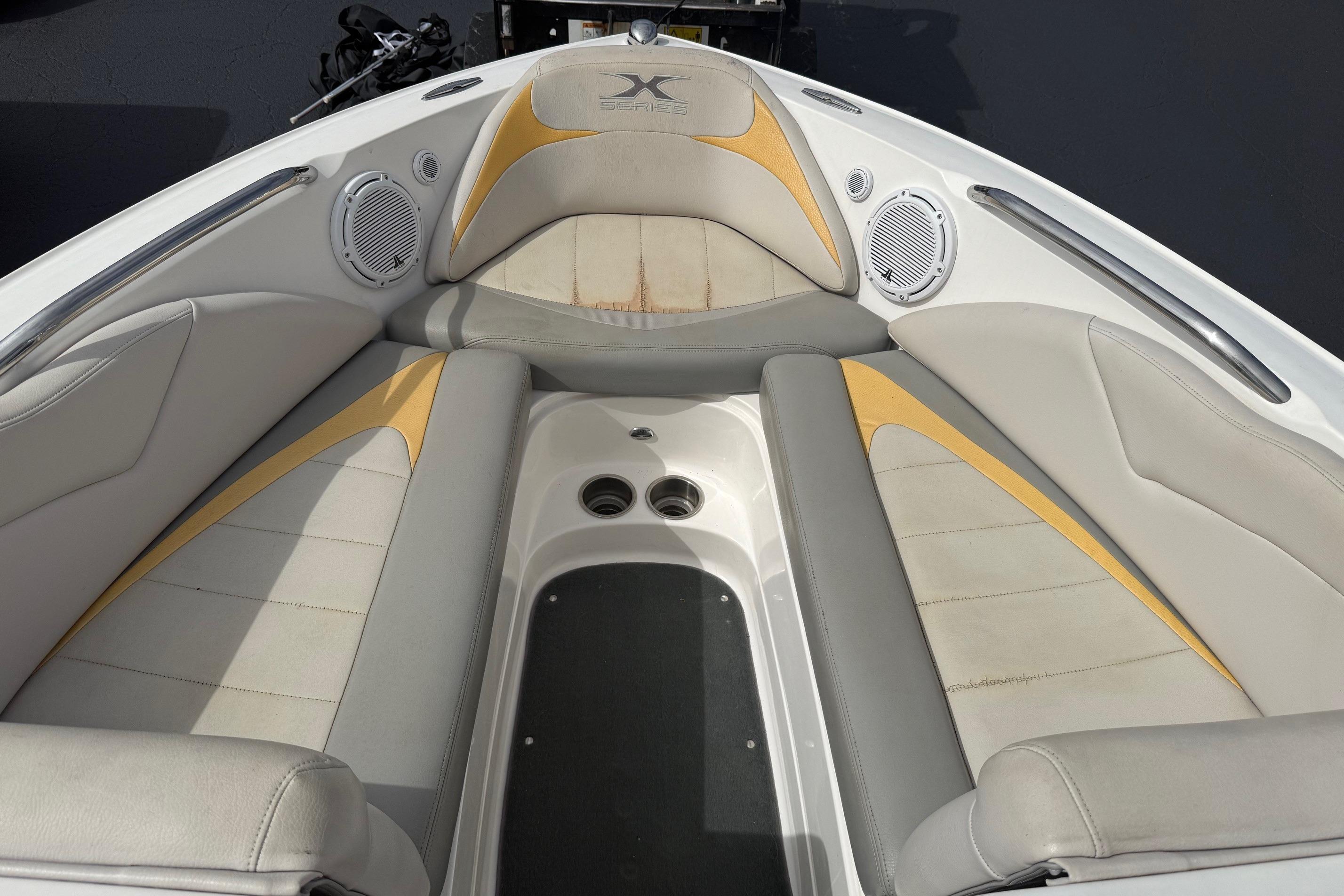 2008 MasterCraft X-15 boat interior with beige and yellow seating, featuring built-in speakers.
