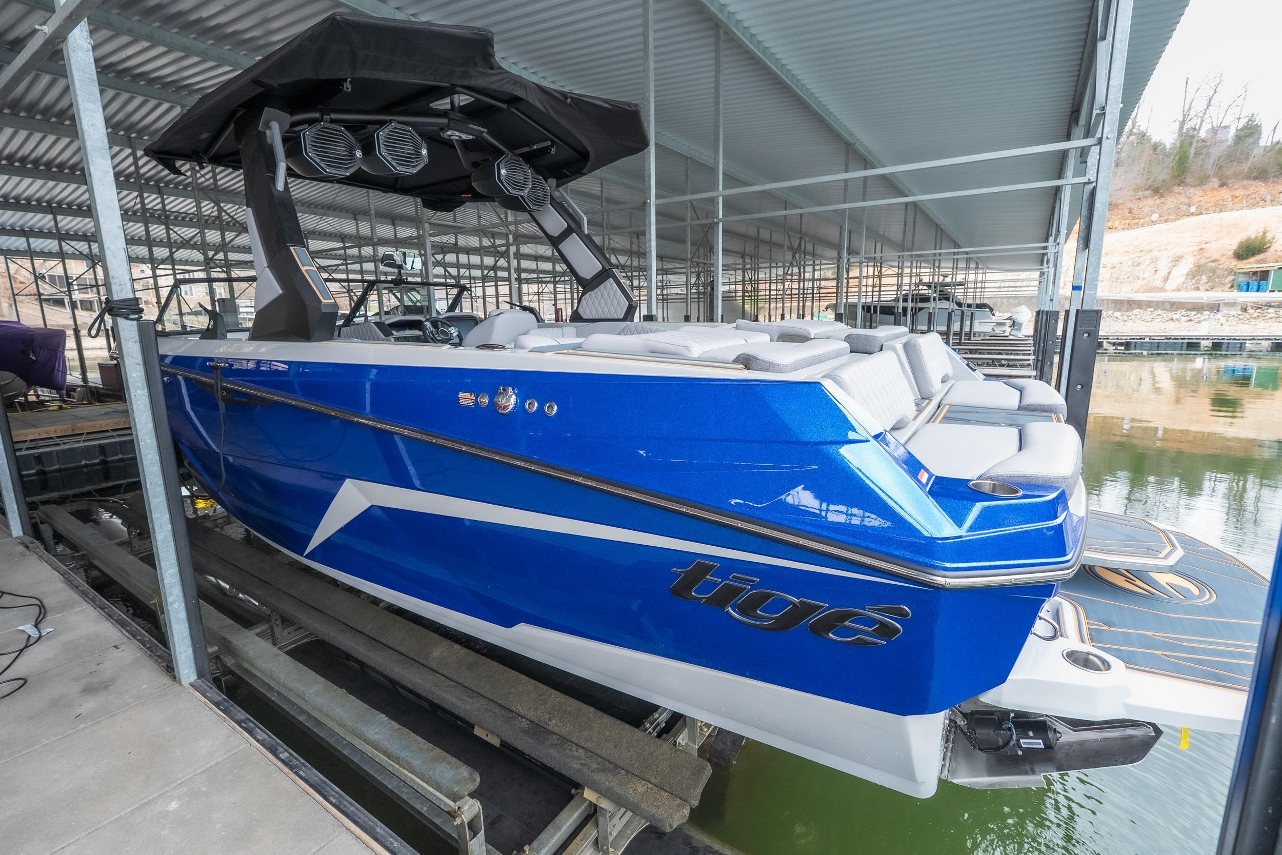 2026 Tigé Z3 boat in vibrant blue, docked under a covered marina.