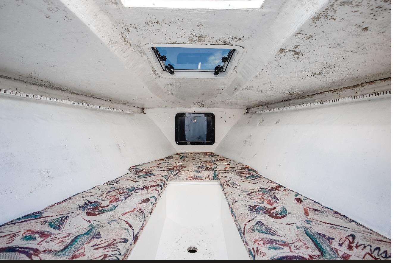 Interior cabin of a 1997 Marlago 35fs boat with patterned cushions.