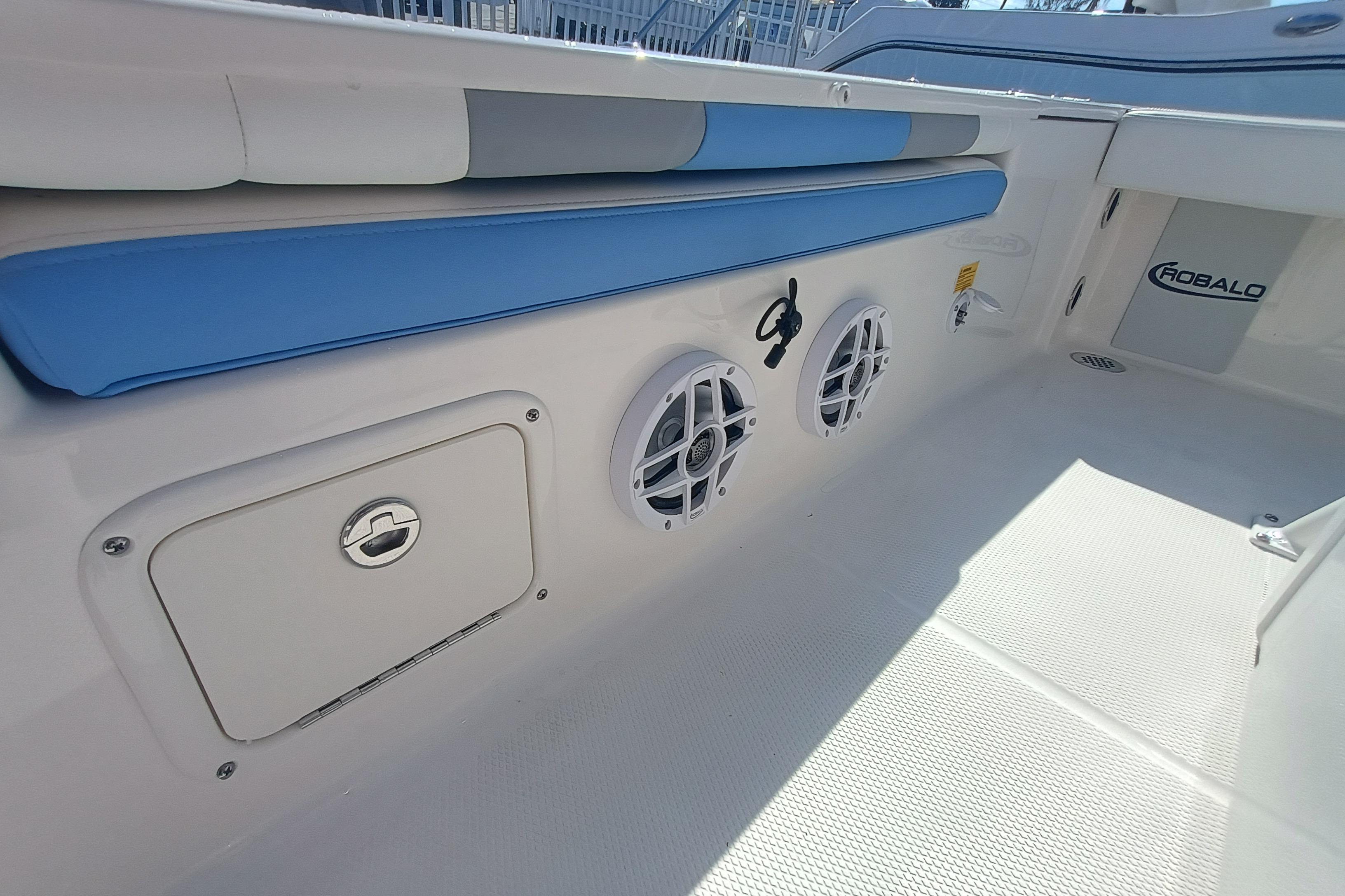 2026 Robalo 226 Cayman boat interior with blue seating and speaker system.