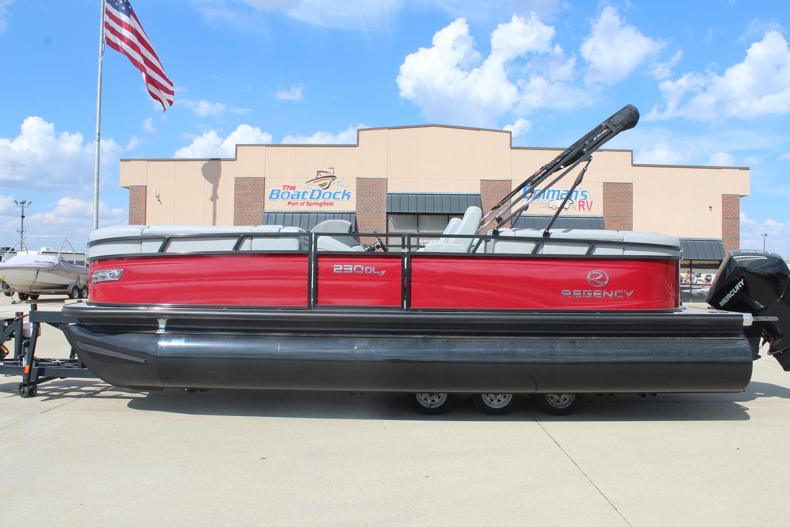2025 Regency 230 DL3 pontoon boat with red exterior at dealership, American flag in background.