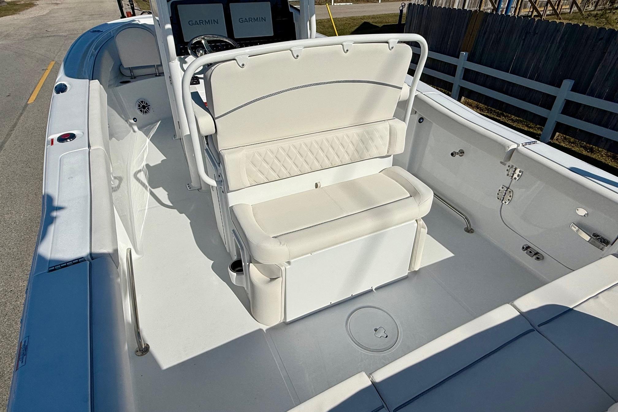 2026 Sea Hunt Ultra 255 SE boat interior with white seating and Garmin displays.