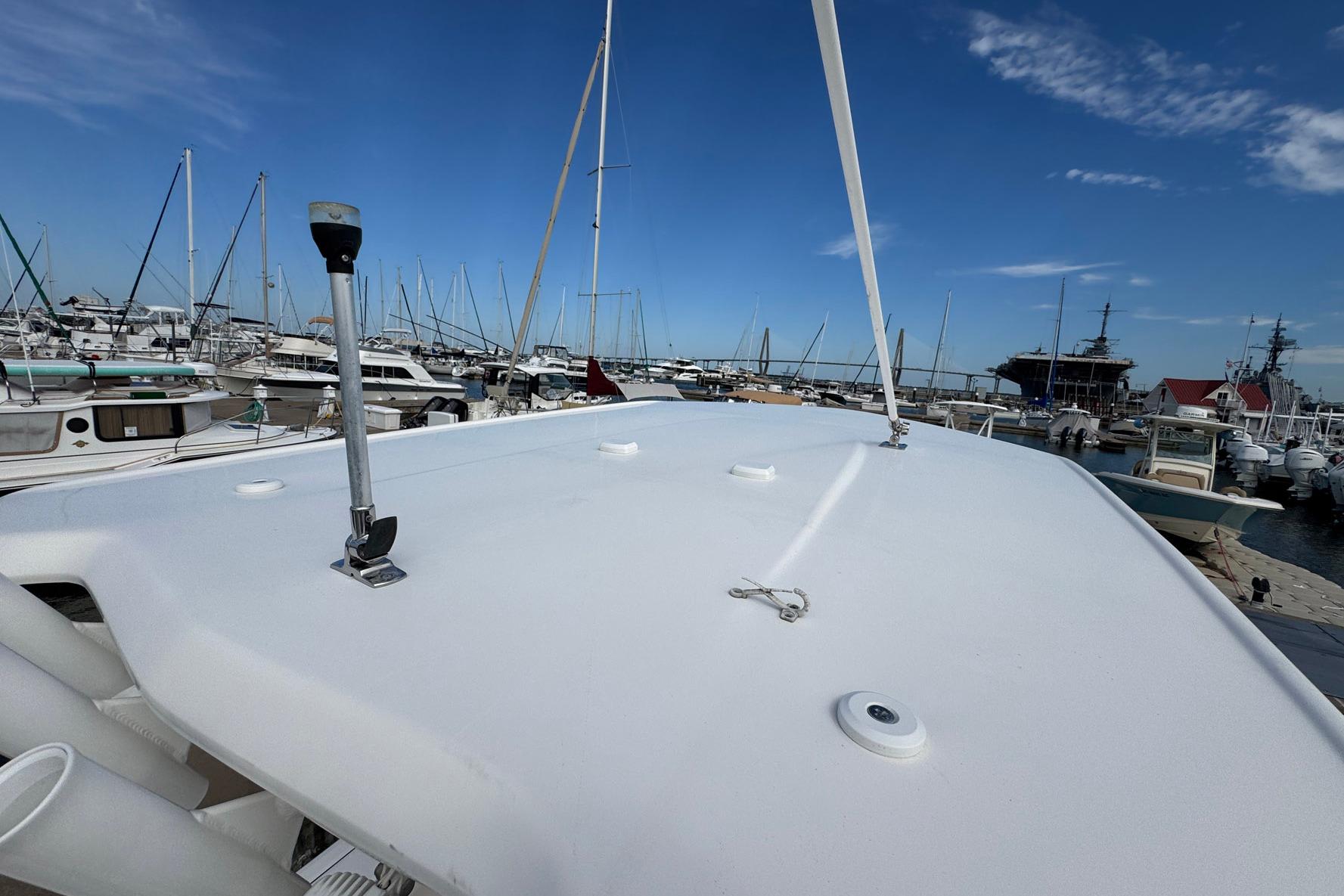 2021 Robalo 246 Cayman boat docked at a marina under clear blue skies.