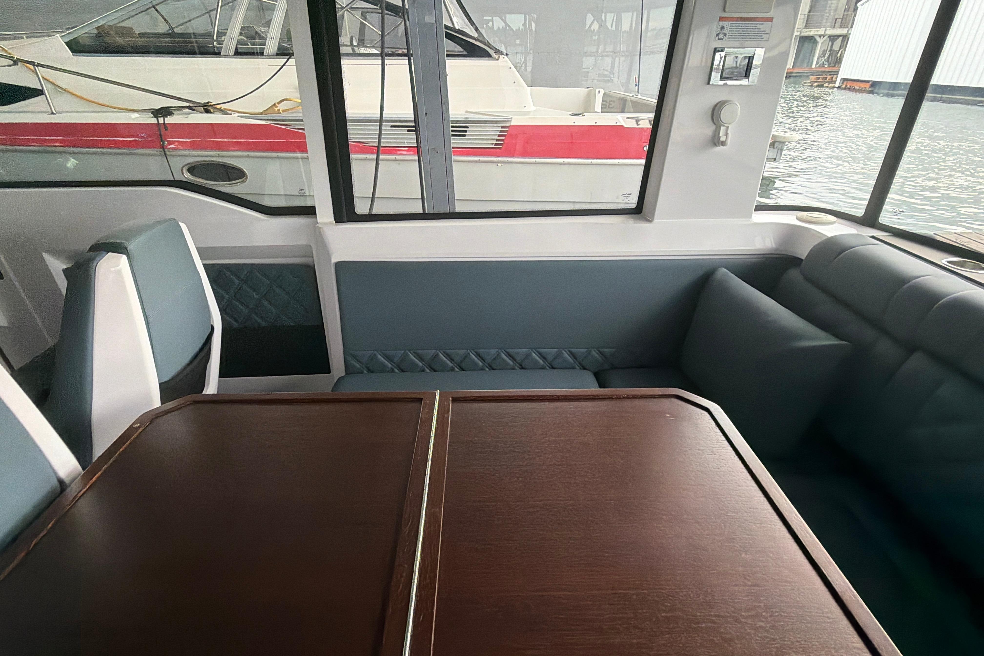 Interior of 2022 Axopar Brabus 37 XC Cross Cabin with elegant seating and table.