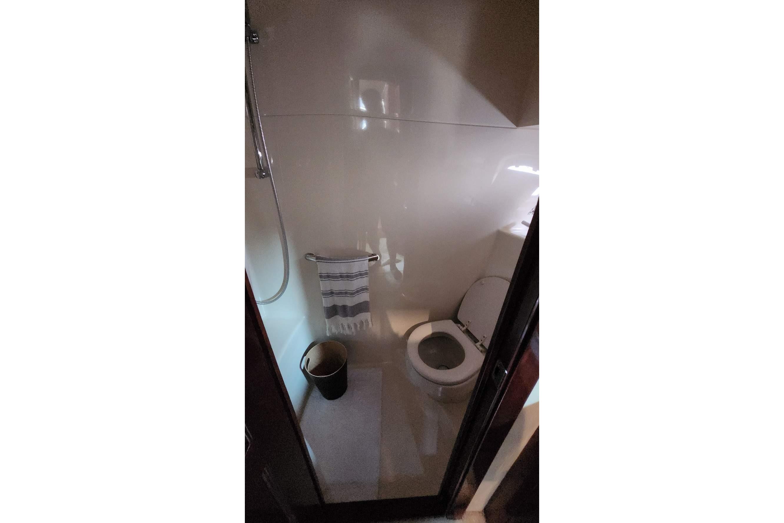 Bathroom interior of 2007 Sea Ray 480 Sundancer yacht, featuring toilet and shower.