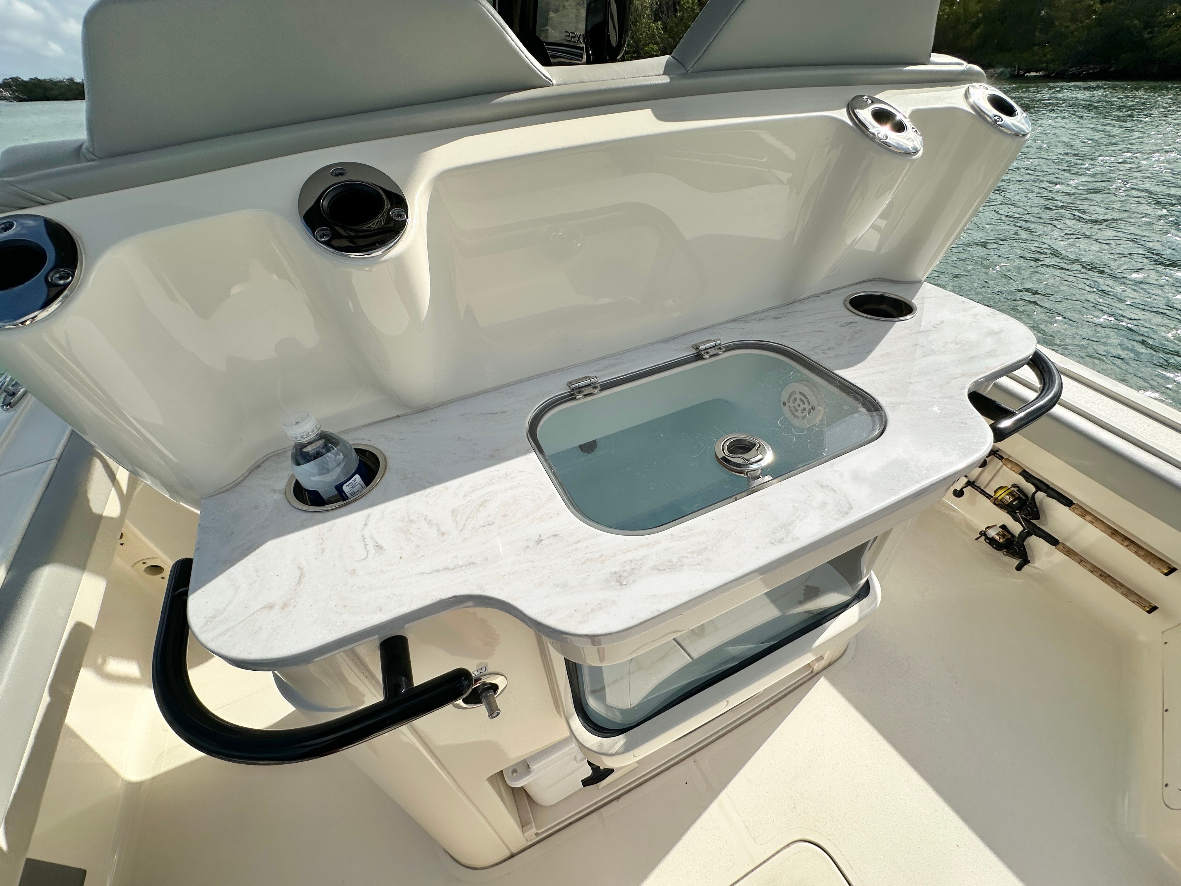 The image shows the cockpit of a 2024 Scout 281 XSS with a countertop and fishing rod holders.