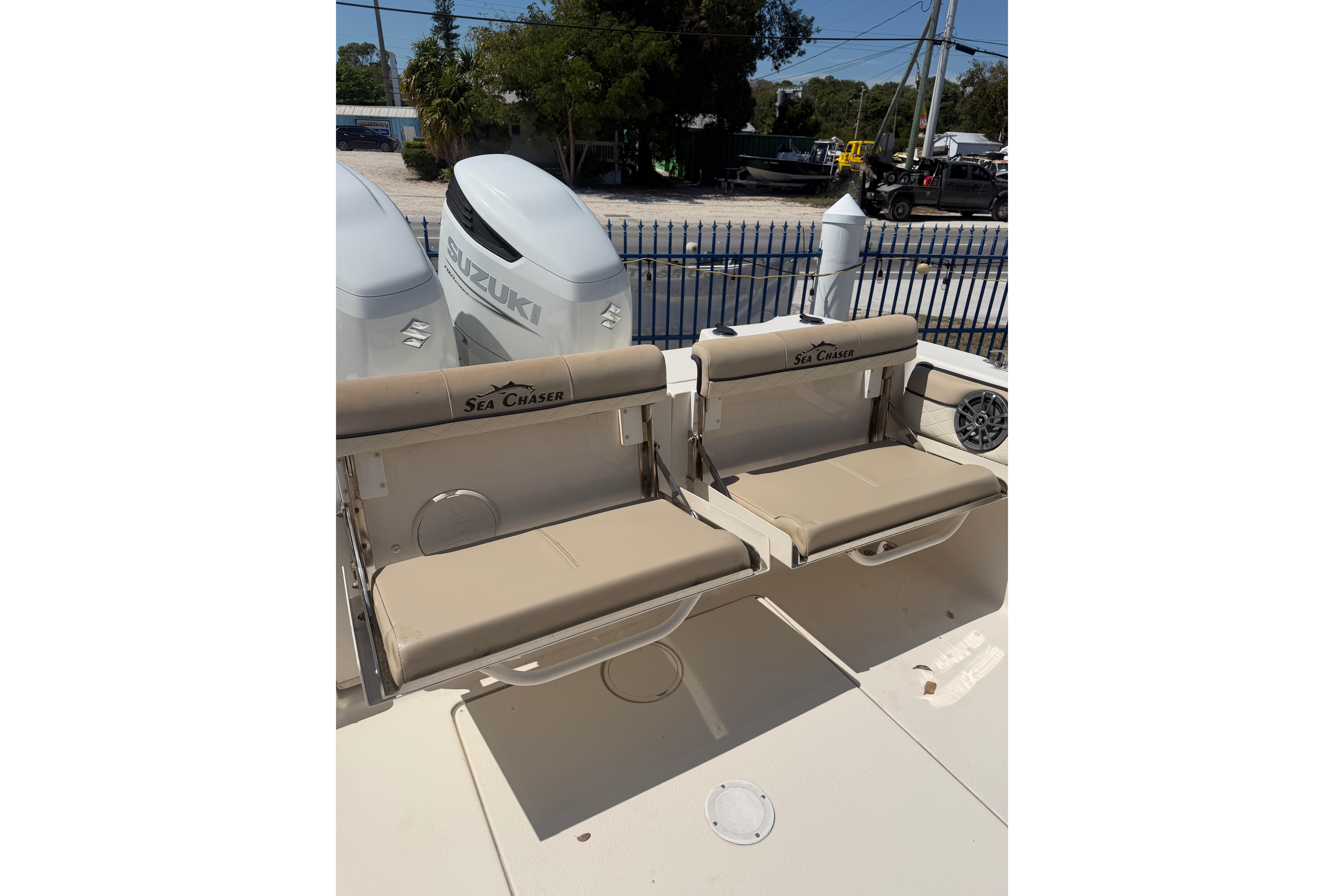 2021 Sea Chaser 30 HFC CC boat with Suzuki engines and beige seating.