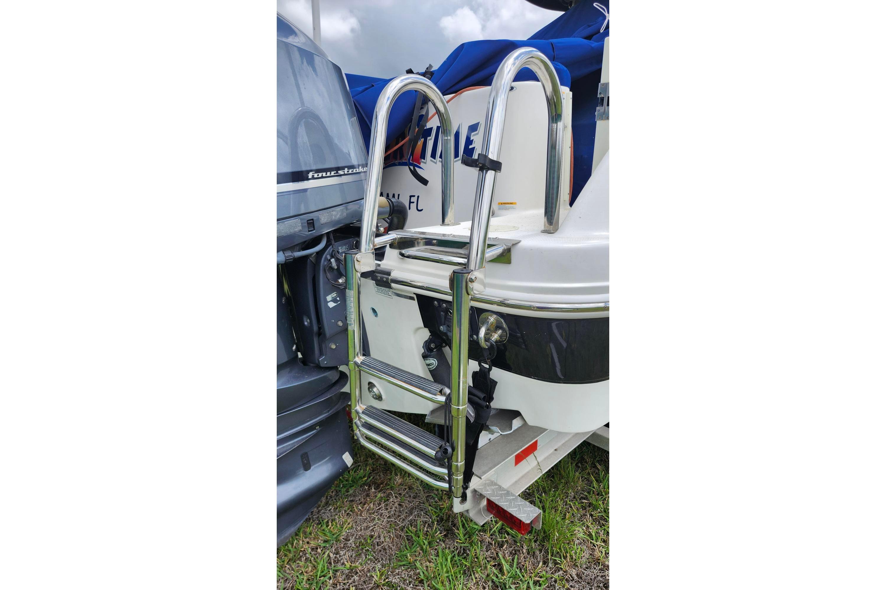 2015 Robalo R300 Center Console boat with stainless steel ladder and outboard motor.