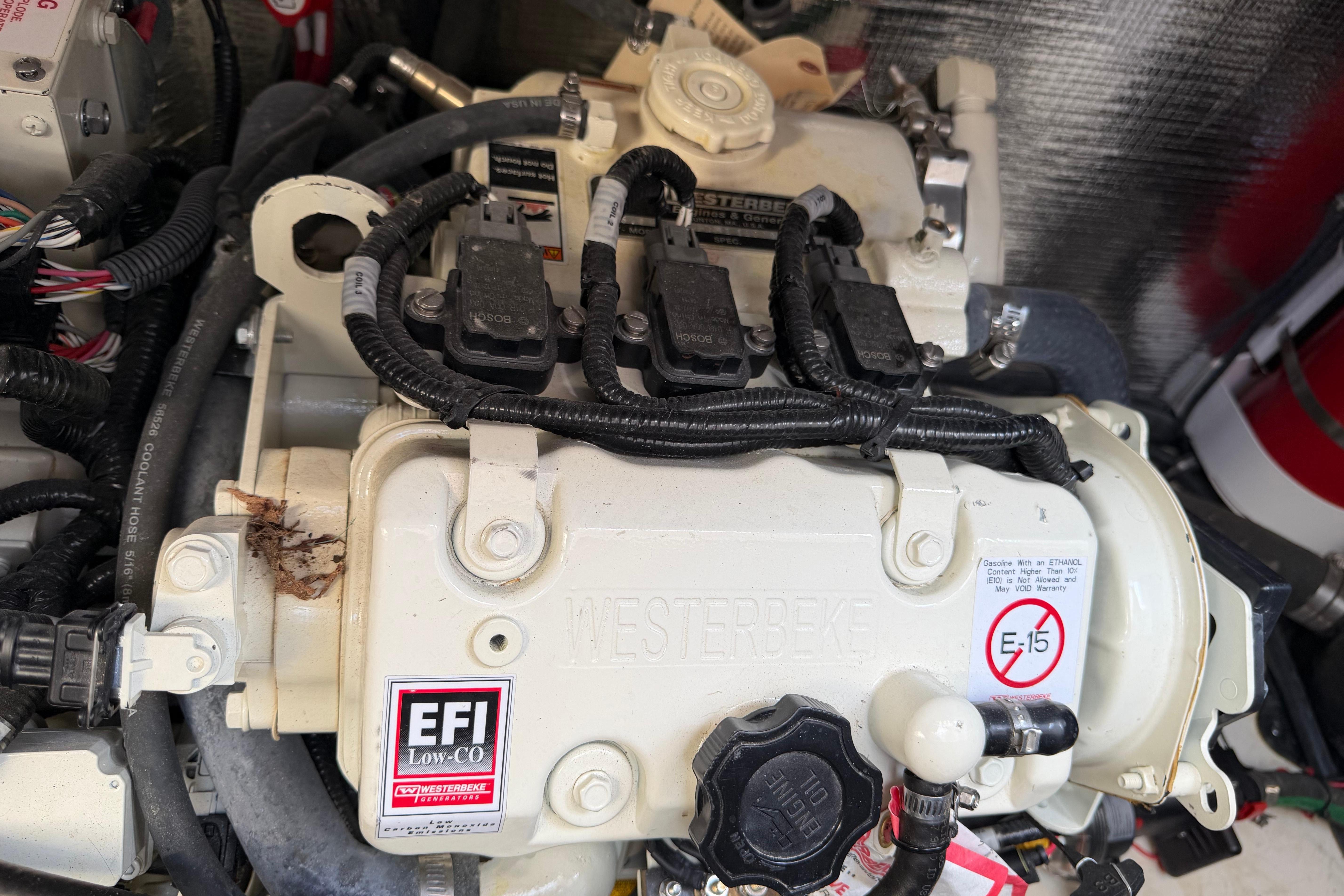 Engine compartment of a 2019 Rinker EX 320 boat, featuring EFI system components.