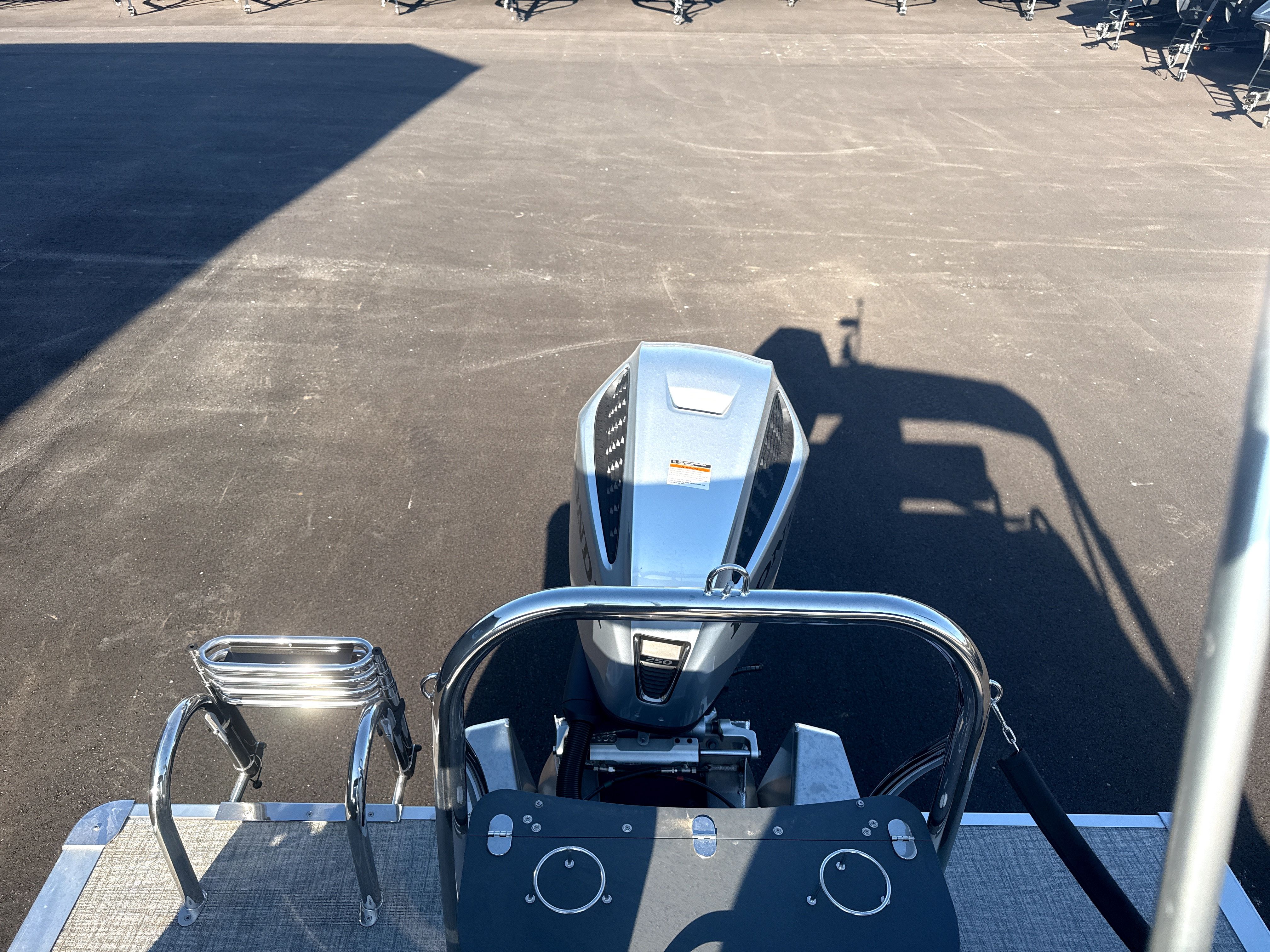 2026 Tahoe LTZ Quad Lounge Shift boat motor on asphalt.