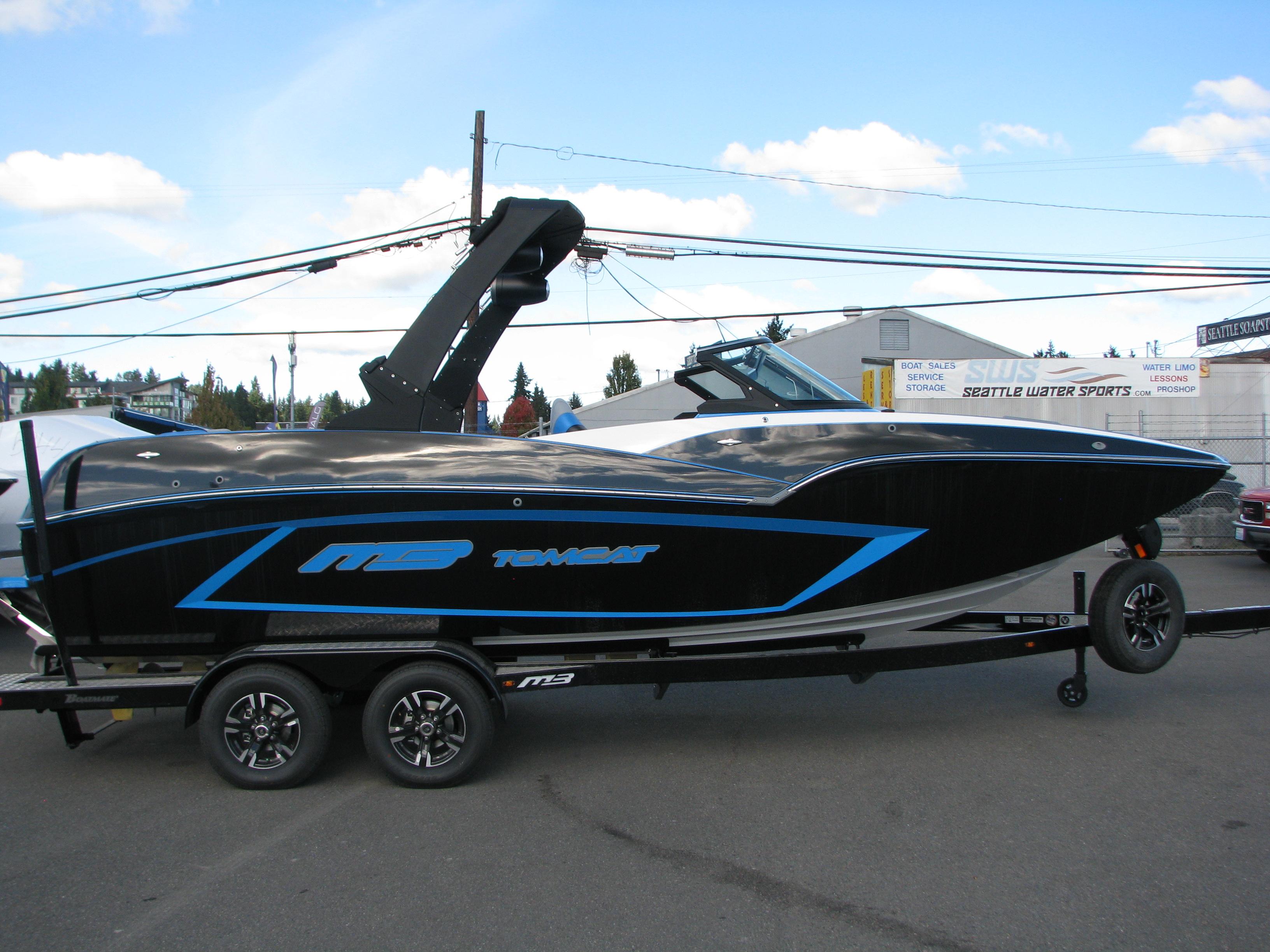 2022 MB F22 Alpha boat on trailer, black and blue design, parked outdoors.