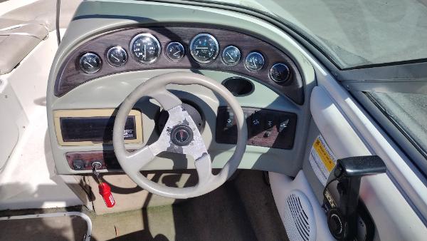 1999 Chaparral 2130 SS boat dashboard with steering wheel and instrument panel.
