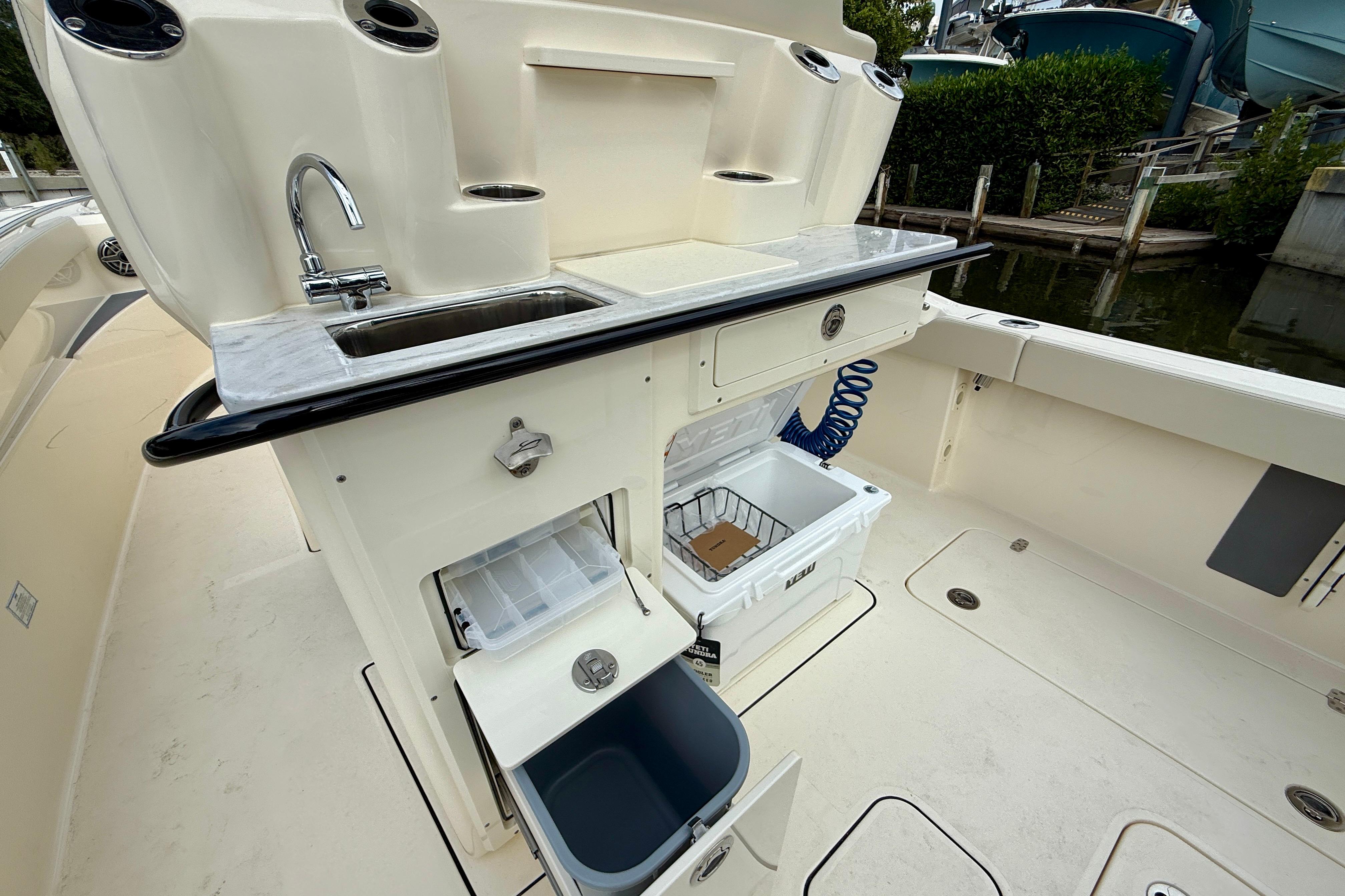 2026 Scout 288 LXF boat with sink, storage, and cooler on deck.