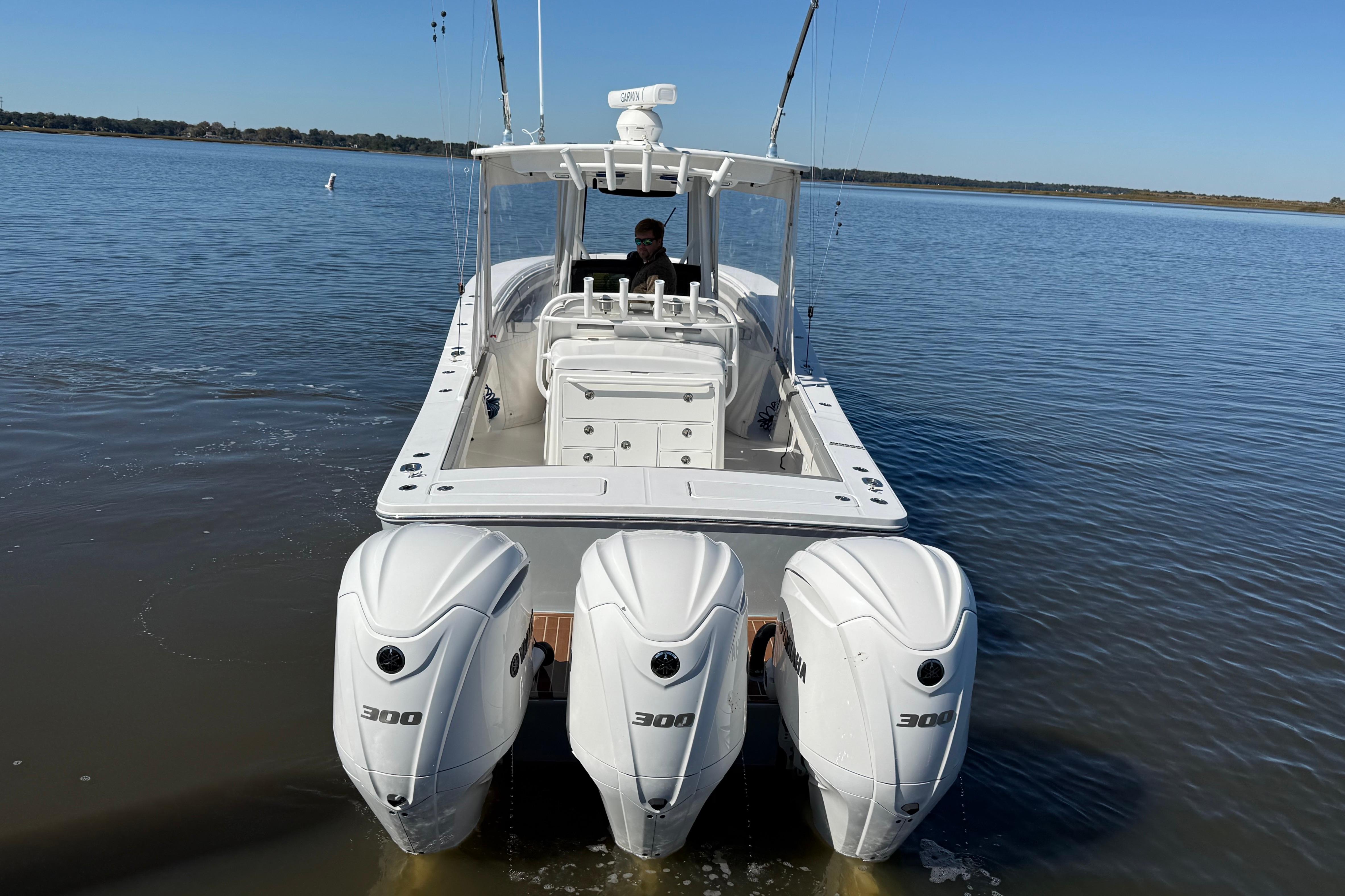 2022 Regulator 34 boat with triple 300 horsepower engines on calm water.