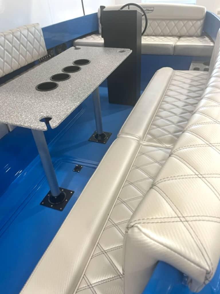2024 Vision Marine Technologies Fantail 217 interior with quilted seating and table.
