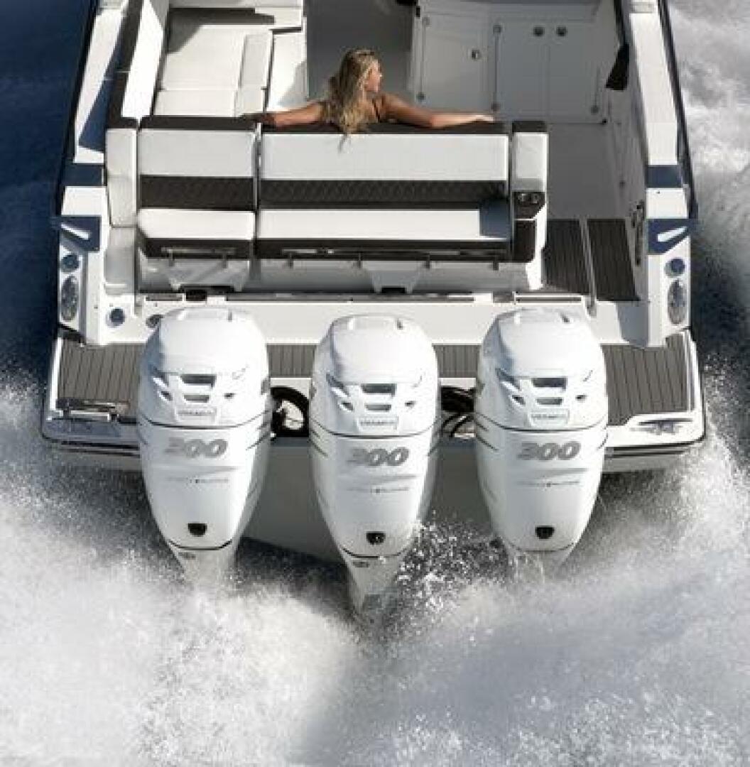 2025 Monterey 385SS boat with triple outboard engines cruising on water.