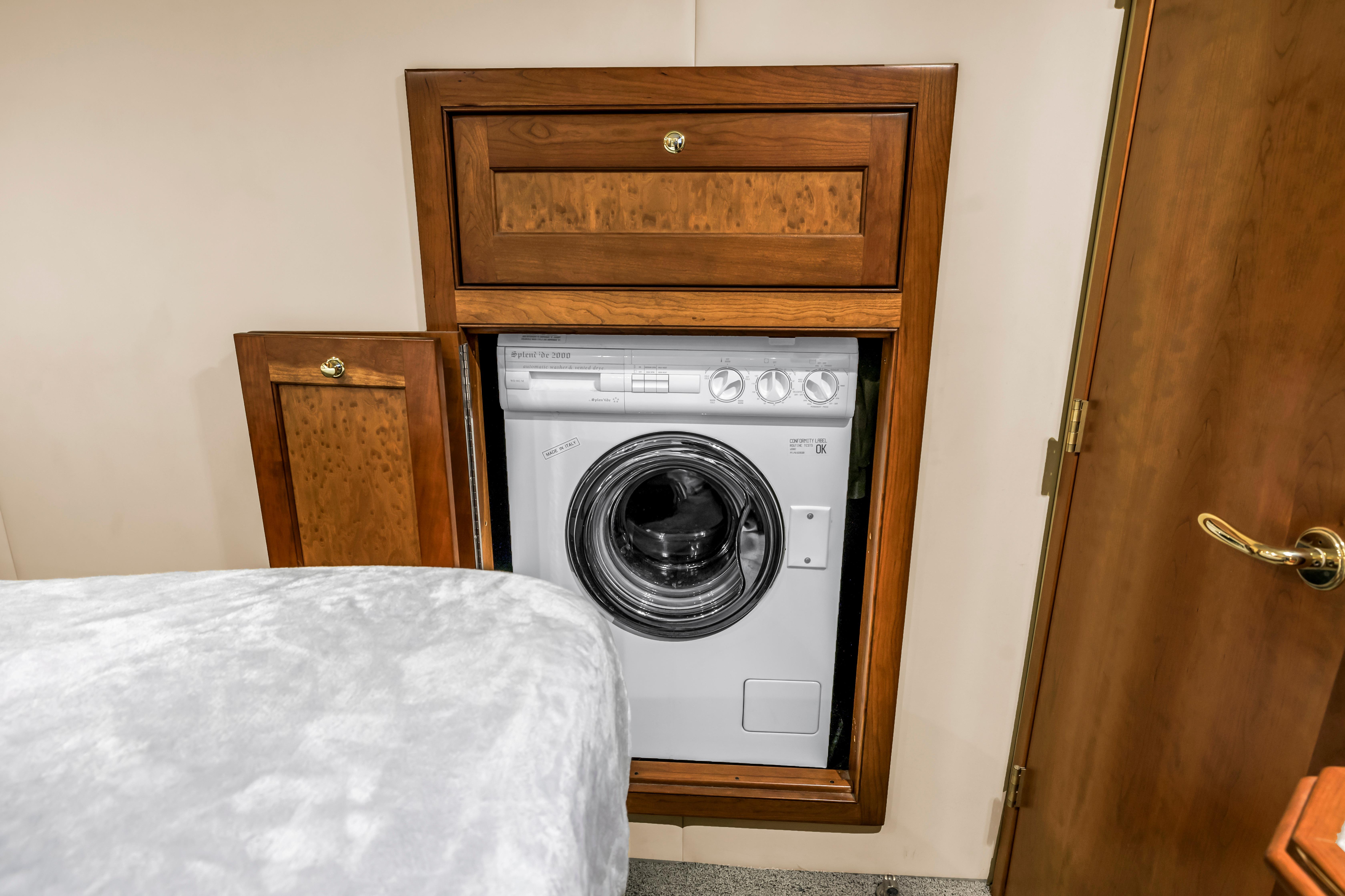 Built-in washing machine in wooden cabinet on 2002 Cruisers 5370 yacht.