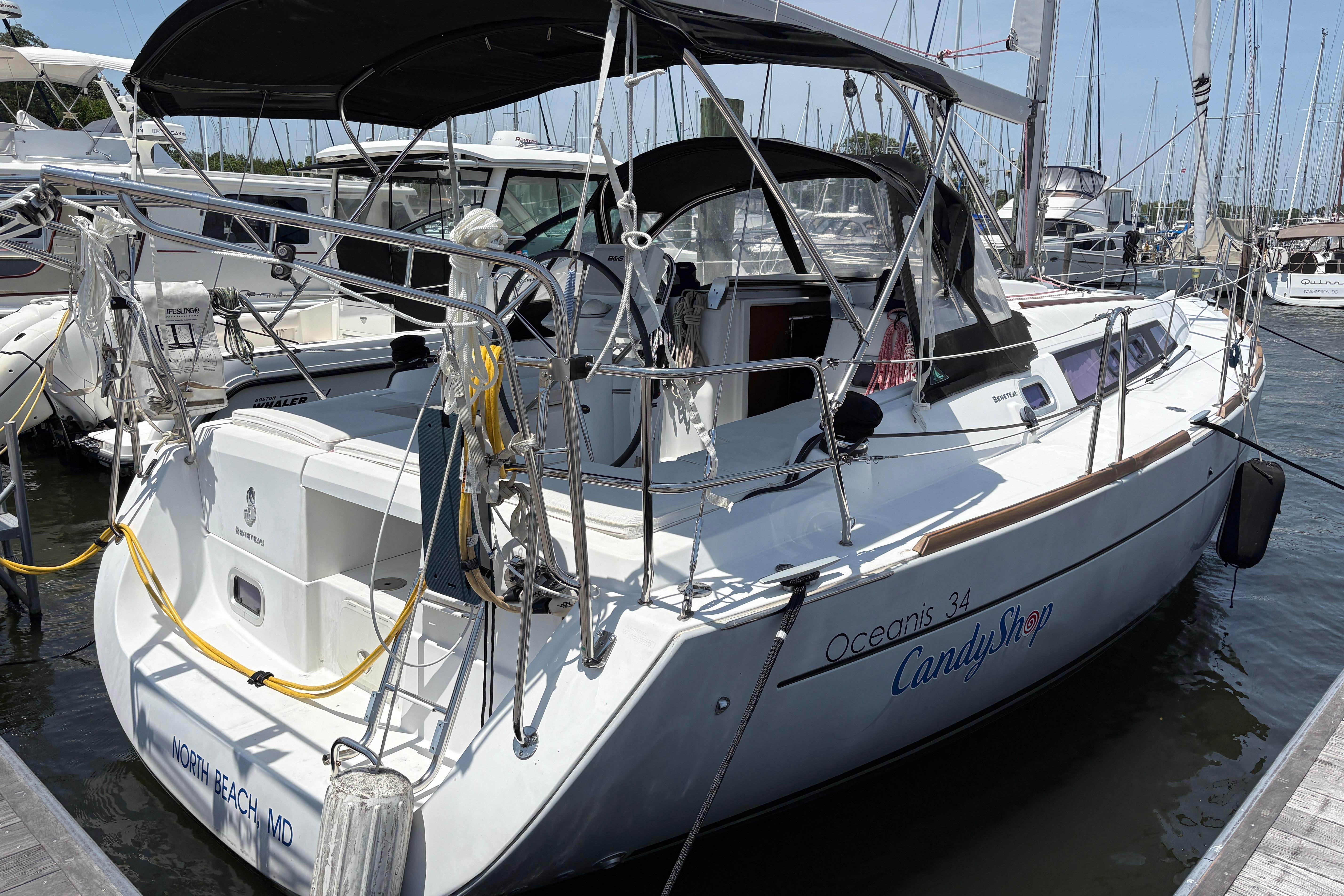 2015 Beneteau Oceanis 34 sailboat docked at marina, featuring sleek design and spacious deck.
